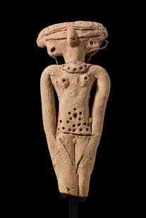 EGYPTIAN TERRACOTTA STATUETTE OF A CONCUBINE: Second Intermediate Period, Ca. 1782 - 1570 BC. A pottery statuette of a standing nude female figure with arms held close to the body and legs together. The broad head with incised eyes and applied no