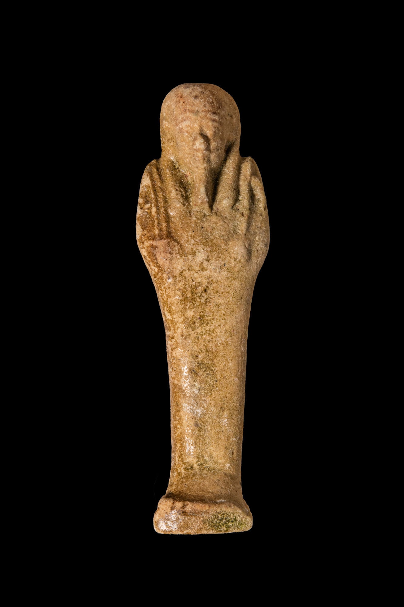 EGYPTIAN FAIENCE USHABTI WITH INSCRIPTION: Late Period, 27th Dynasty, Ca. 500 BC. A faience ushabti wearing a tripartite wig framing a small oval face with a plaited false beard, the slim mummiform body tapering to a narrow square plinth. The