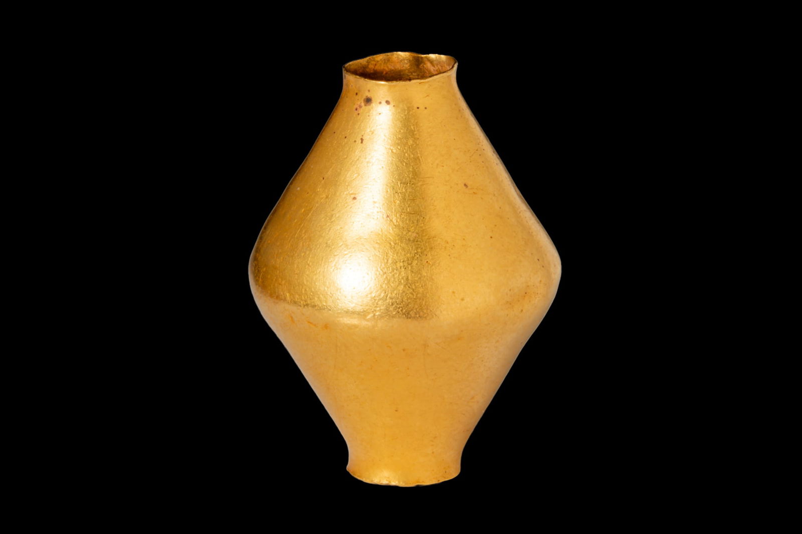 HELLENISTIC GOLD BICONICAL BEAD: Ca. 400 - 300 BCA gold biconical bead with a narrow cylindrical opening at each end.Size: 34mm x 24mm; Weight: 13.1g.Prince collection, 1990s-2014; Ex. Private collection 1970s-1990s.This item has bee