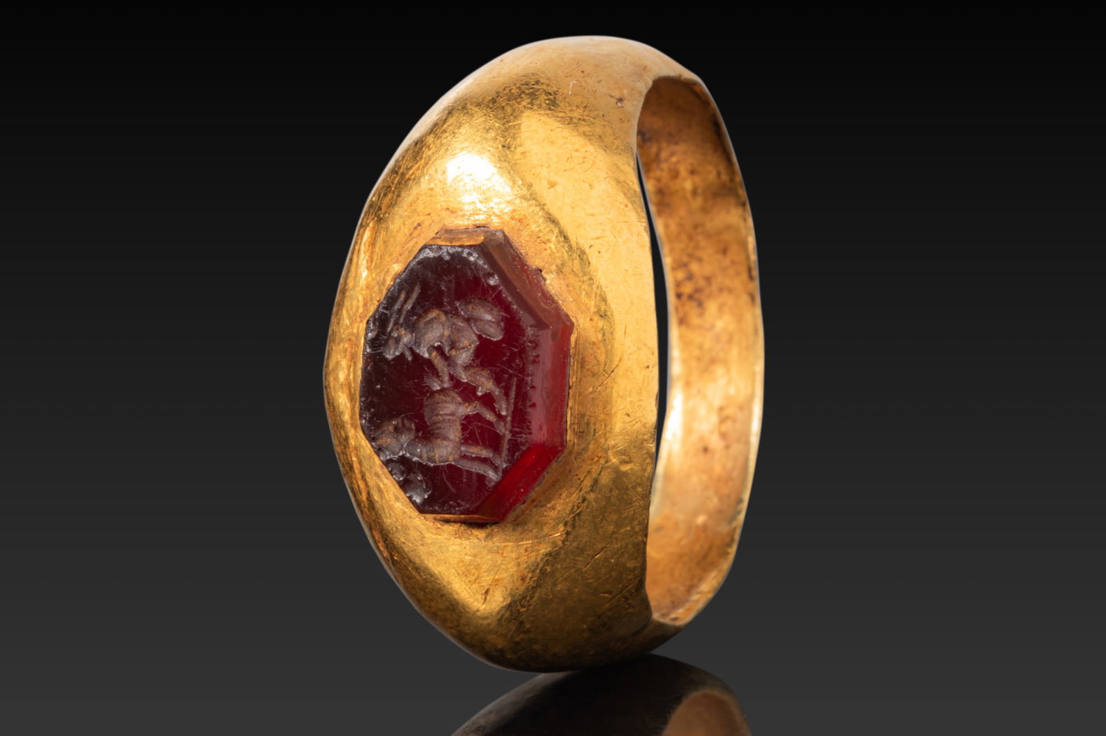 LARGE ROMAN HIGH KARAT GOLD RING WITH CARNELIAN INTAGLIO OF A SHEPHERD MILKING A SHEEP (1 of 3)