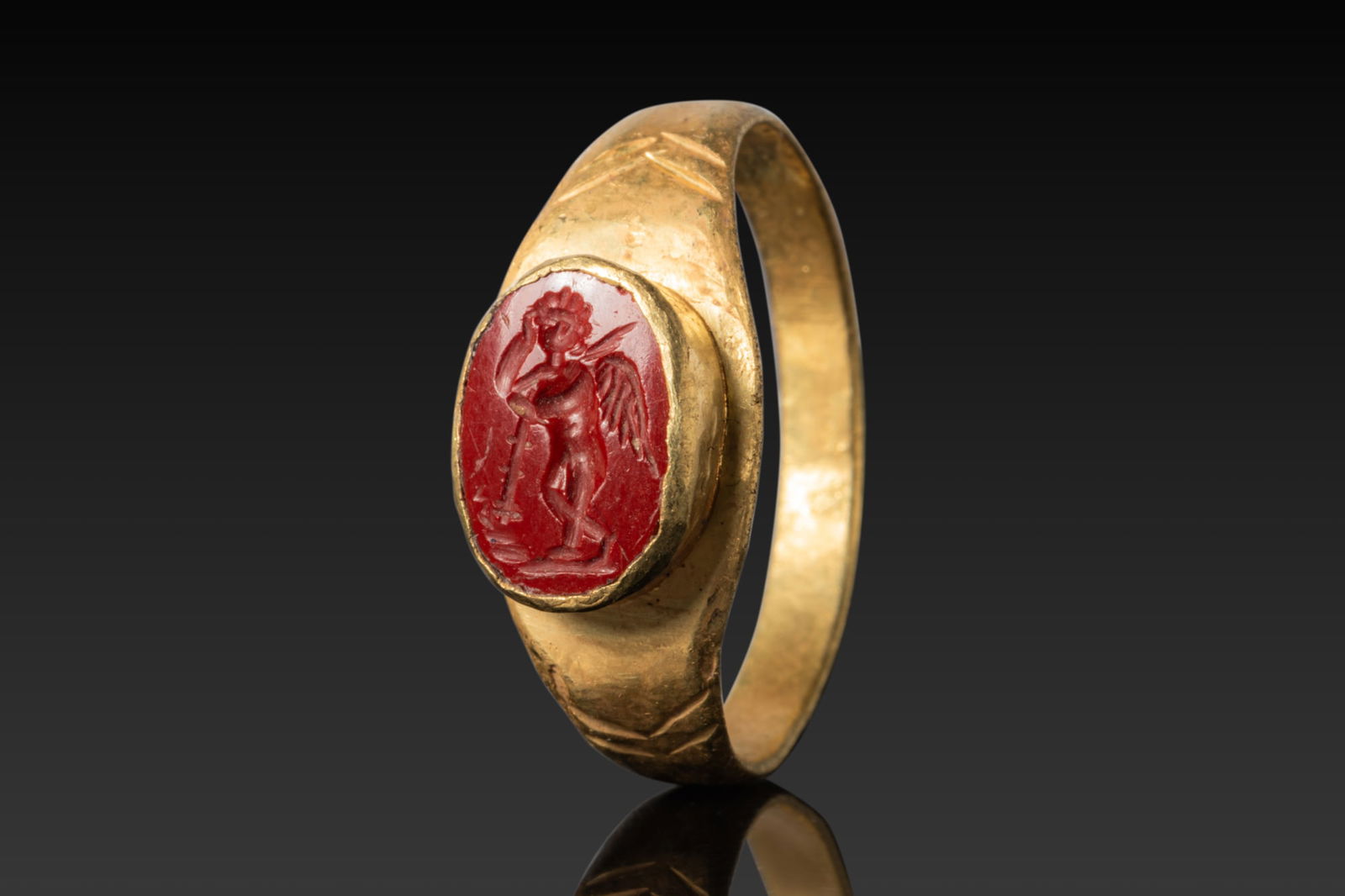 ROMAN HIGH KARAT GOLD RING WITH RED JASPER INTAGLIO OF CUPID RESTING ON A CLUB (1 of 3)