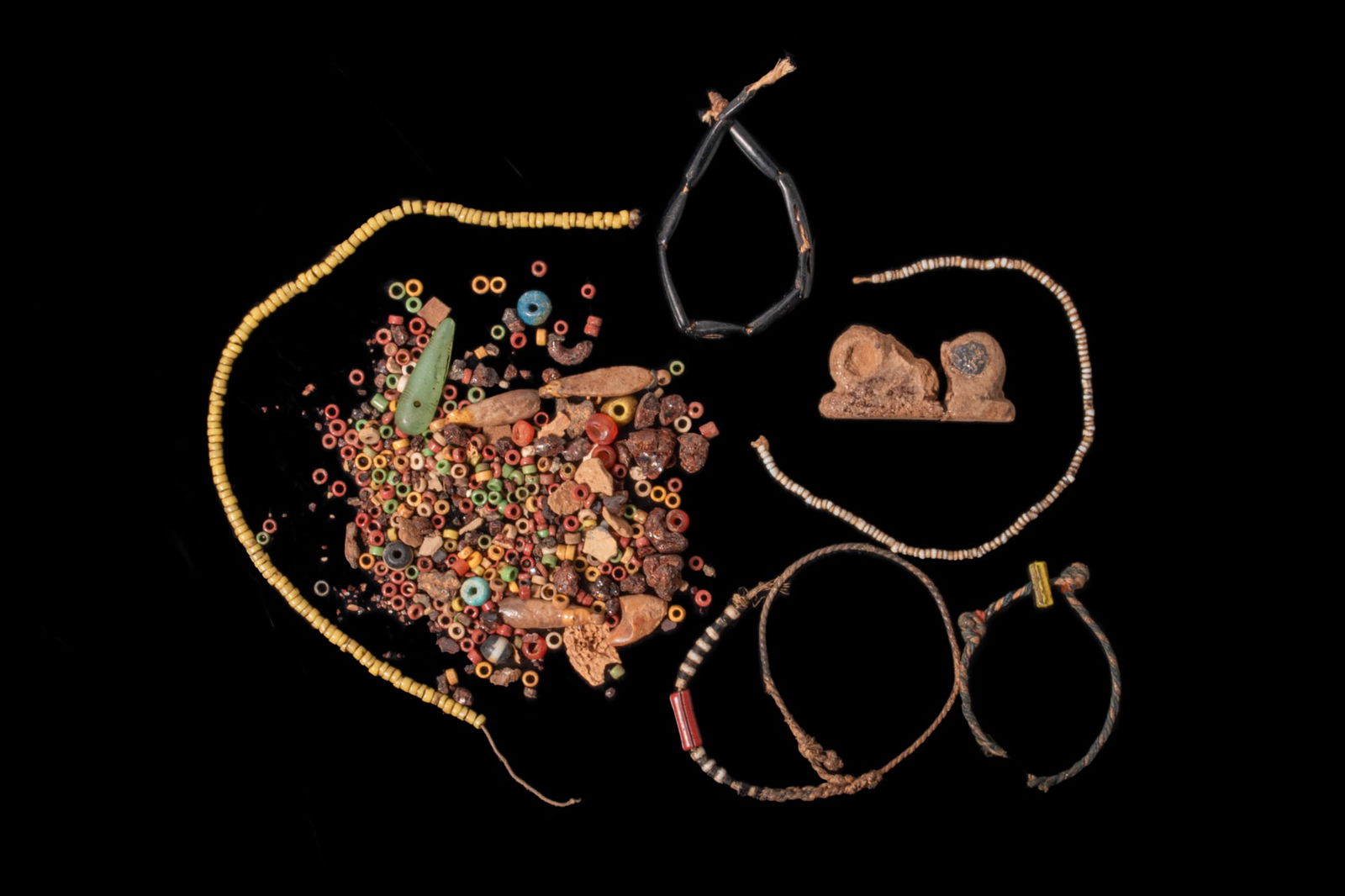 LARGE COLLECTION OF EGYPTIAN STONE, FAIENCE AND GLASS BEADS: New Kingdom to Late Period, Ca. 1550 - 332 BCA large collection of stone, faience and glass beads, including a long strand of yellow disc beads, a loose assemblage of tiny annular beads in red, yellow