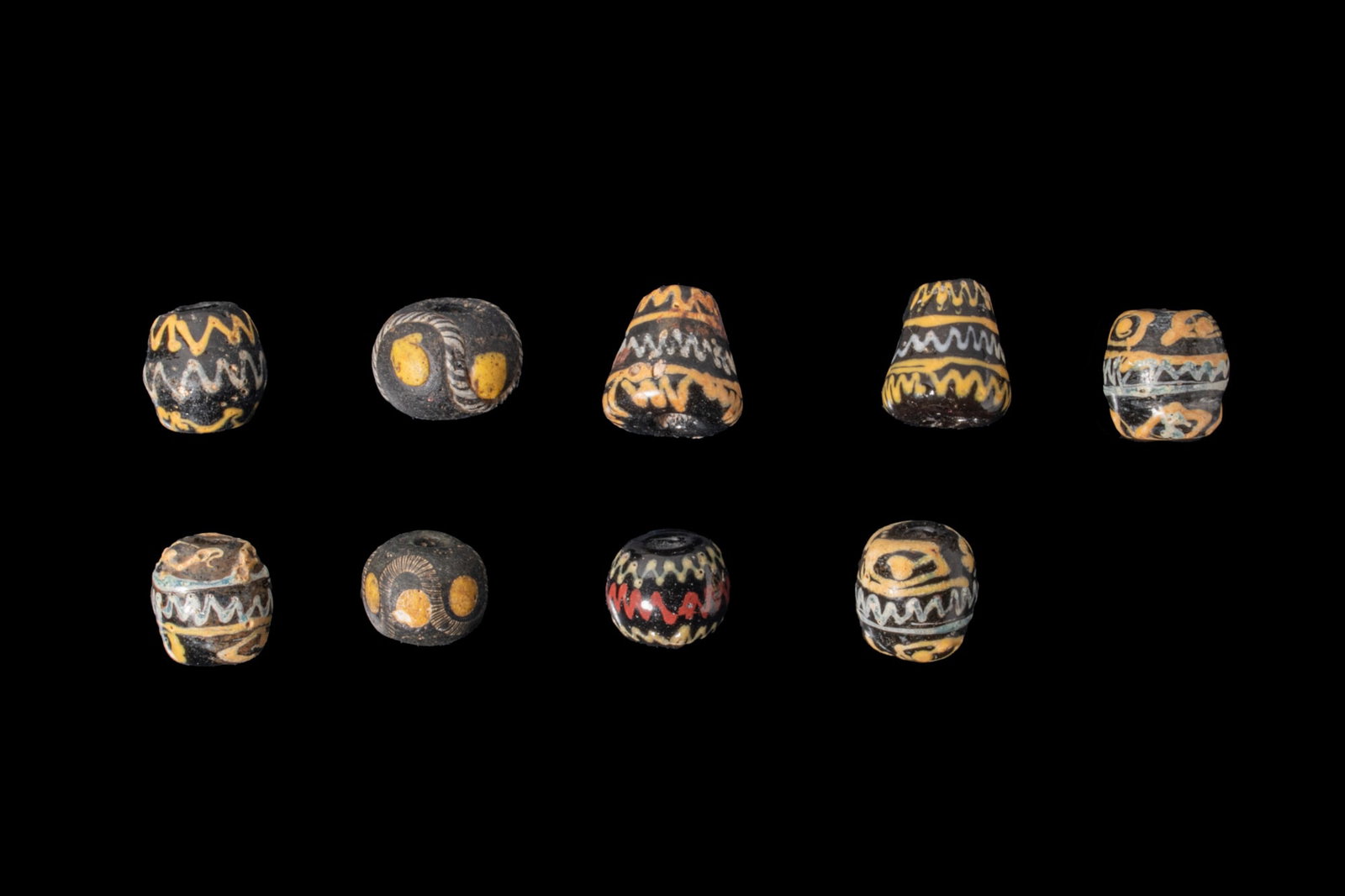 COLLECTION OF GRAECO PHOENICIAN GLASS BEADS WITH WAVE MOTIFS (1 of 3)