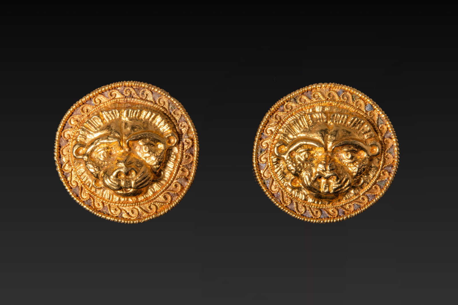 PAIR OF GREEK HIGH KARAT GOLD AND ENAMEL LION-HEAD APPLIQU?S (1 of 9)