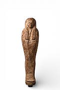EGYPTIAN WOODEN PTAH-SOKAR-OSIRIS: Late Period, Ca. 664 - 332 BC A wooden Ptah-Sokar-Osiris statuette, shown mummiform beneath a tripartite wig, the face modelled in low relief. The body tapers to a rounded base with a projecting tenon