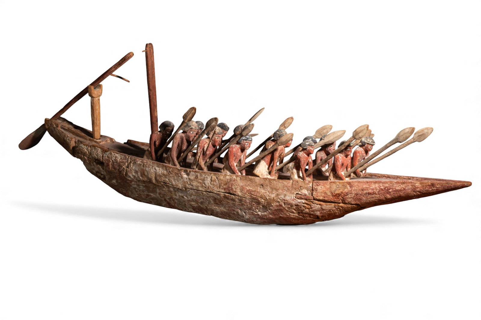 HUGE EGYPTIAN WOODEN MODEL BOAT WITH ROWERS AND OARS - 1.5 meters: Middle Kingdom, Ca. 2055 - 1790 BCA large wooden model boat under oars, the long narrow hull carved from a single piece with a pointed bow and a slightly raised stern, the interior hollowed. Fourteen