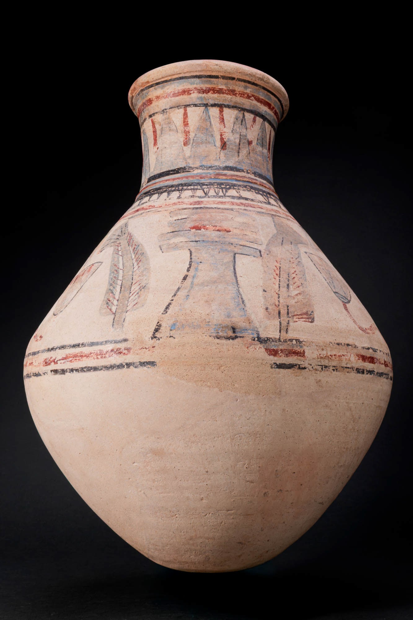 EGYPTIAN BLUE-PAINTED TERRACOTTA JAR WITH DJED PILLARS AND ANKHS: Amarna Period, Ca. 1353 - 1336 BC. A terracotta jar with a biconical body, a squat neck, and a rounded lip, decorated in red, black, and blue pigment. The neck is painted with a band of vertical