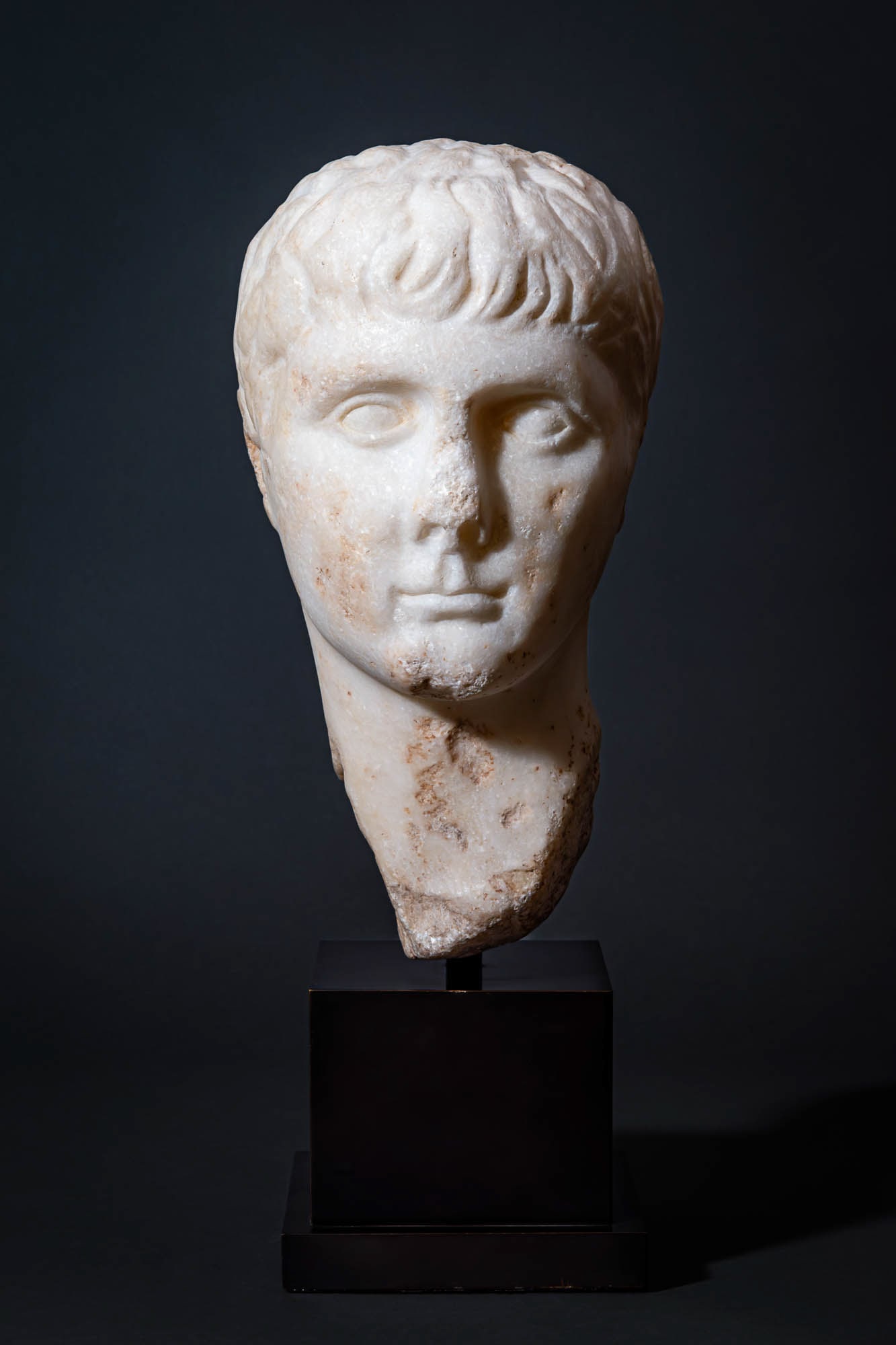 ROMAN MARBLE HEAD OF GAIUS - EX CHRISTIE'S: Ca. AD 1 - 50 A Superb marble portrait of Gaius Caesar, probably of Parian marble, the youth depicted turning slightly to his left, the close-cropped hair carved in wavy locks around the forehead, wit