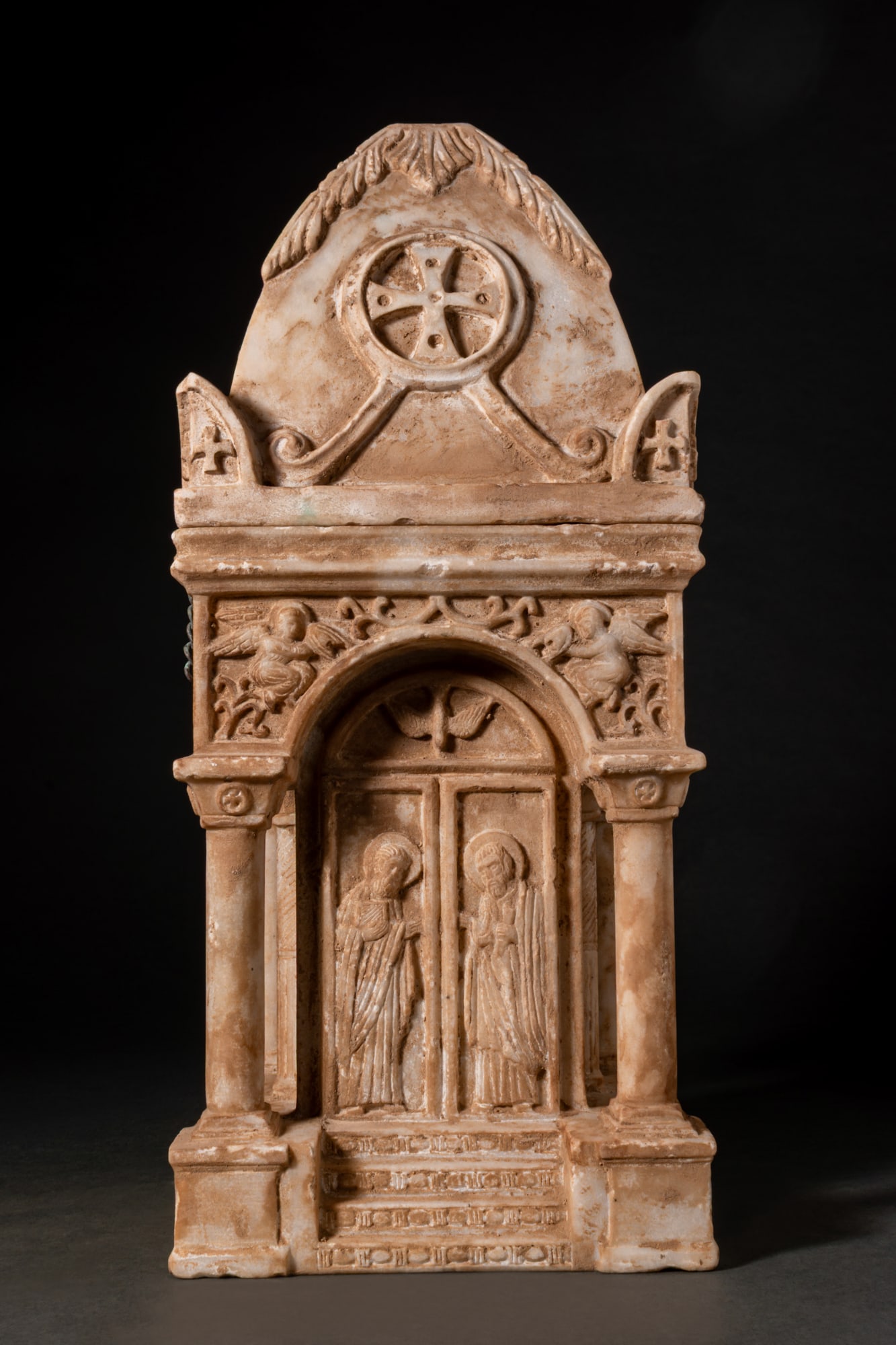 BYZANTINE MARBLE CHURCH-SHAPED RELIQUARY CASKET (CIBORIUM): Ca. AD 600 - 800 A lidded marble reliquary casket in the form of an architectural ciborium, carved in two parts with a square body and a steep pyramidal lid. The lid is decorated along each face with