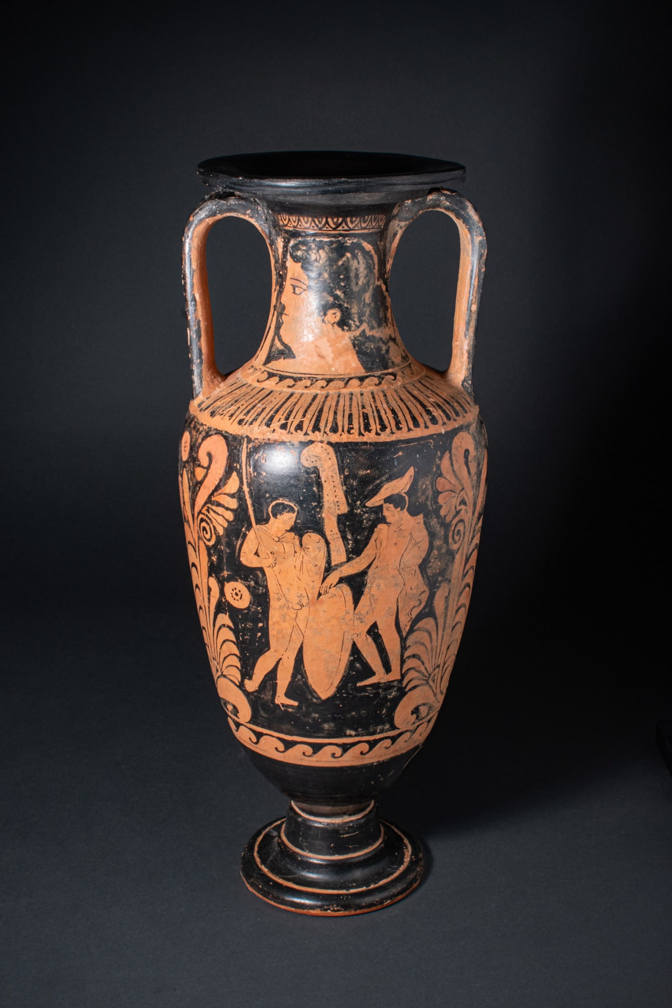 CAMPANIAN RED-FIGURE PANATHENAIC AMPHORA WITH WARRIORS: Ca. 330 BCA red-figure amphora with a tall ovoid body on a high moulded foot, rising to a cylindrical neck with a broad outturned rim, the pair of vertical strap handles joining the neck to the should