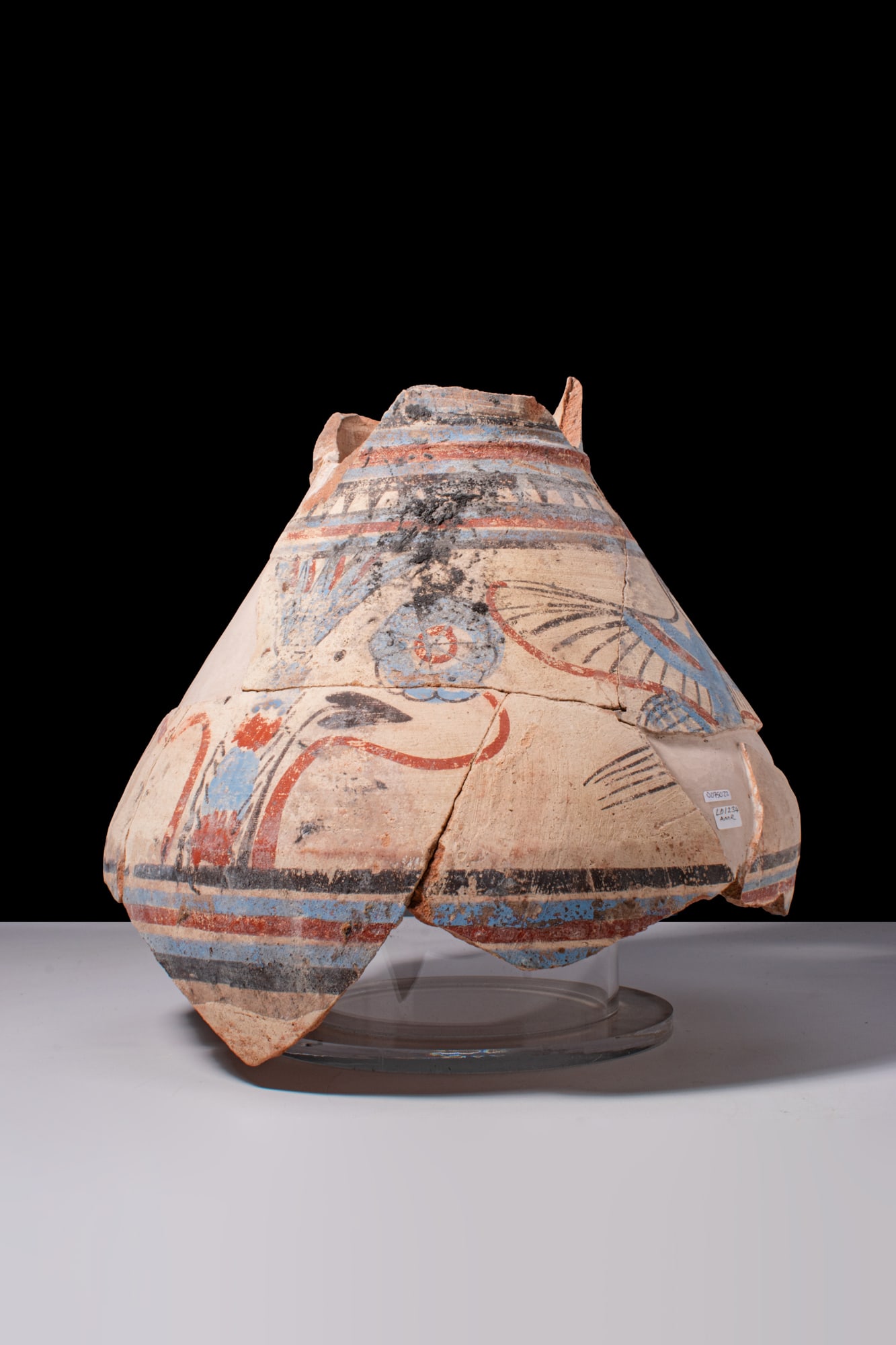 EGYPTIAN PAINTED POTTERY JAR WITH NILOTIC SCENE: Amarna Period, Ca. 1353 - 1336 BCA large painted pottery jar with a broad shoulder decorated with horizontal bands and a Nilotic frieze showing a long-necked bird striding among tall lotus plants and