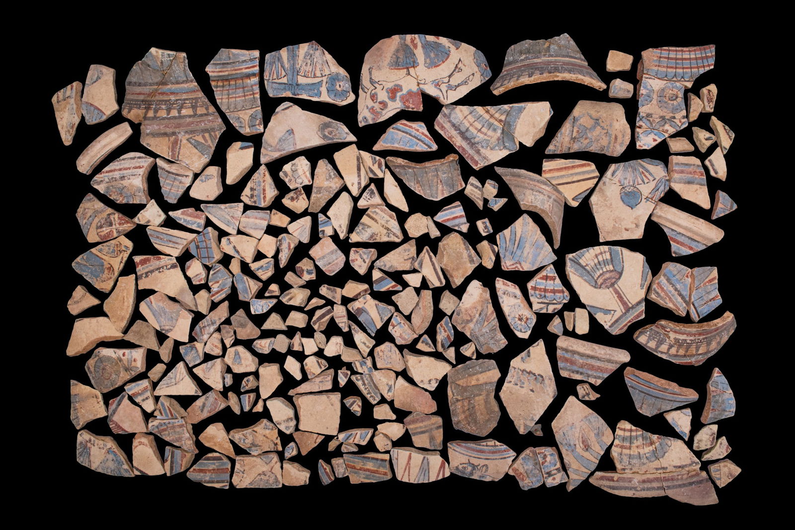 LARGE COLLECTION OF EGYPTIAN POLYCHROME PAINTED POTTERY SHERDS: Amarna Period, Ca. 1353 - 1336 BCA large collection of pottery sherds, each in a light fabric, with remains of polychrome painted ornament including horizontal bands, lattices, pendant petals, lotus