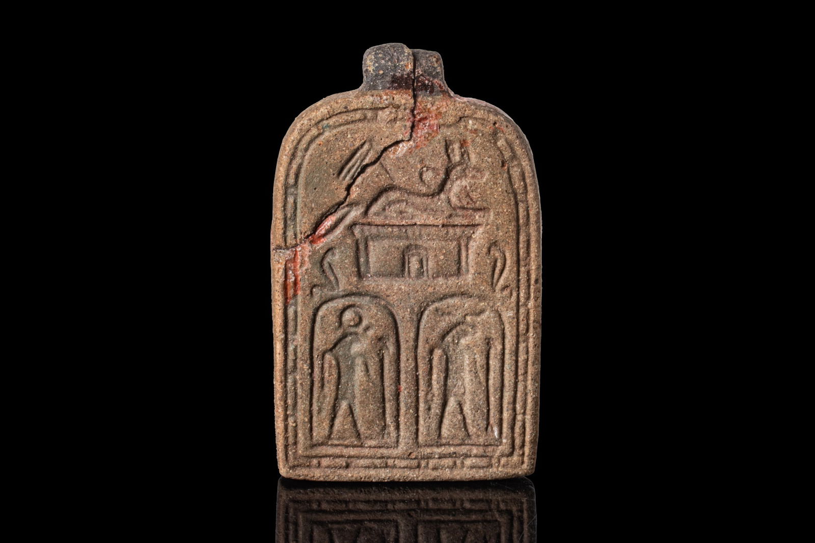 EGYPTO-PHOENICIAN FAIENCE PENDANT WITH DEITIES: Ca. 600 - 500 BCA faience pendant in the form of a rectangular plaque with a rounded top and an integral suspension lug, each face framed by a double border and moulded in low relief. One side is