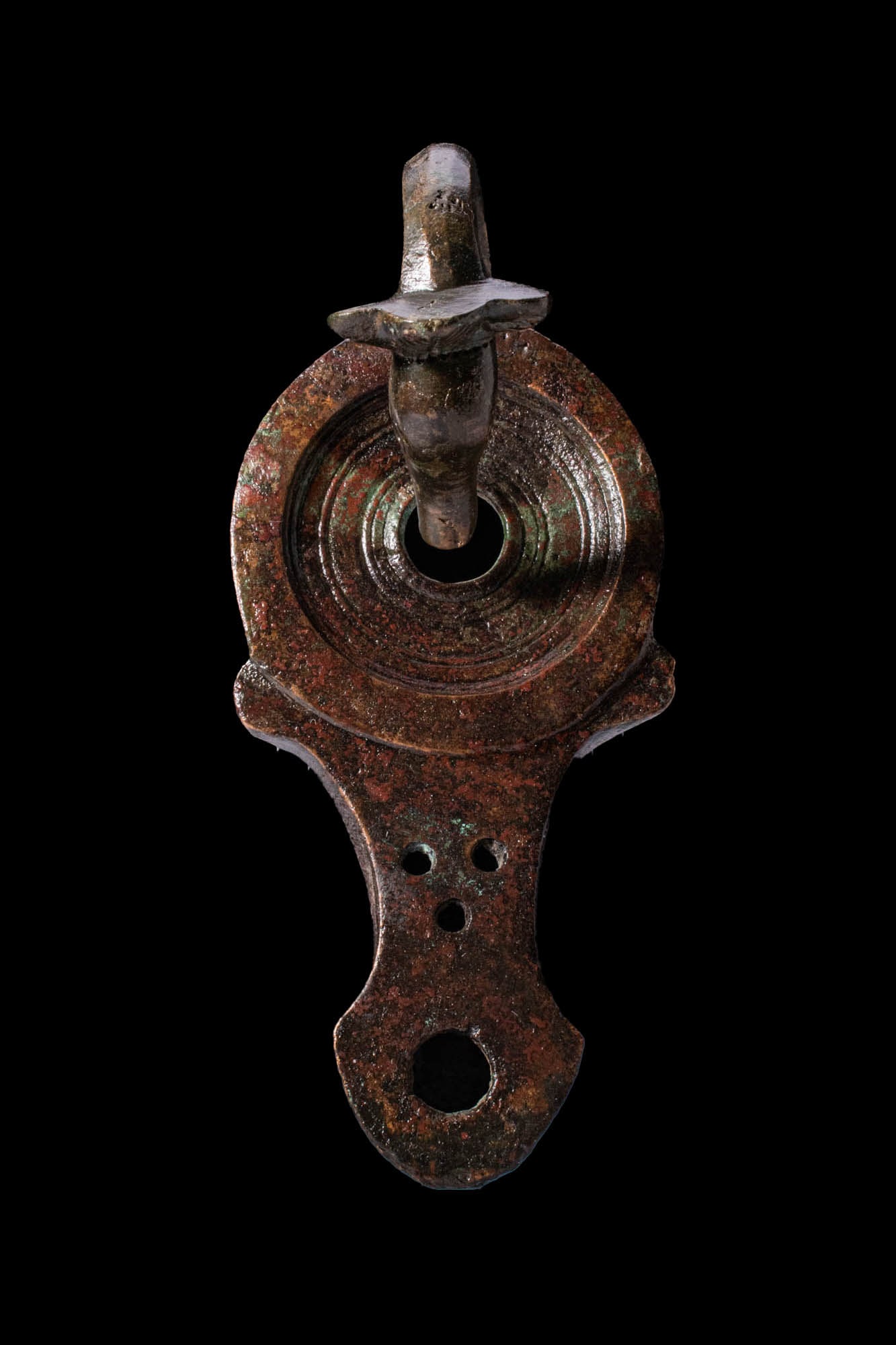 LARGE ROMAN BRONZE OIL LAMP WITH SWAN HANDLE: Ca. AD 50 - 150. A heavy bronze oil lamp with a rounded body and a long, tapering nozzle pierced with three small holes and terminating in an angled spout. The tondo is decorated with a series of