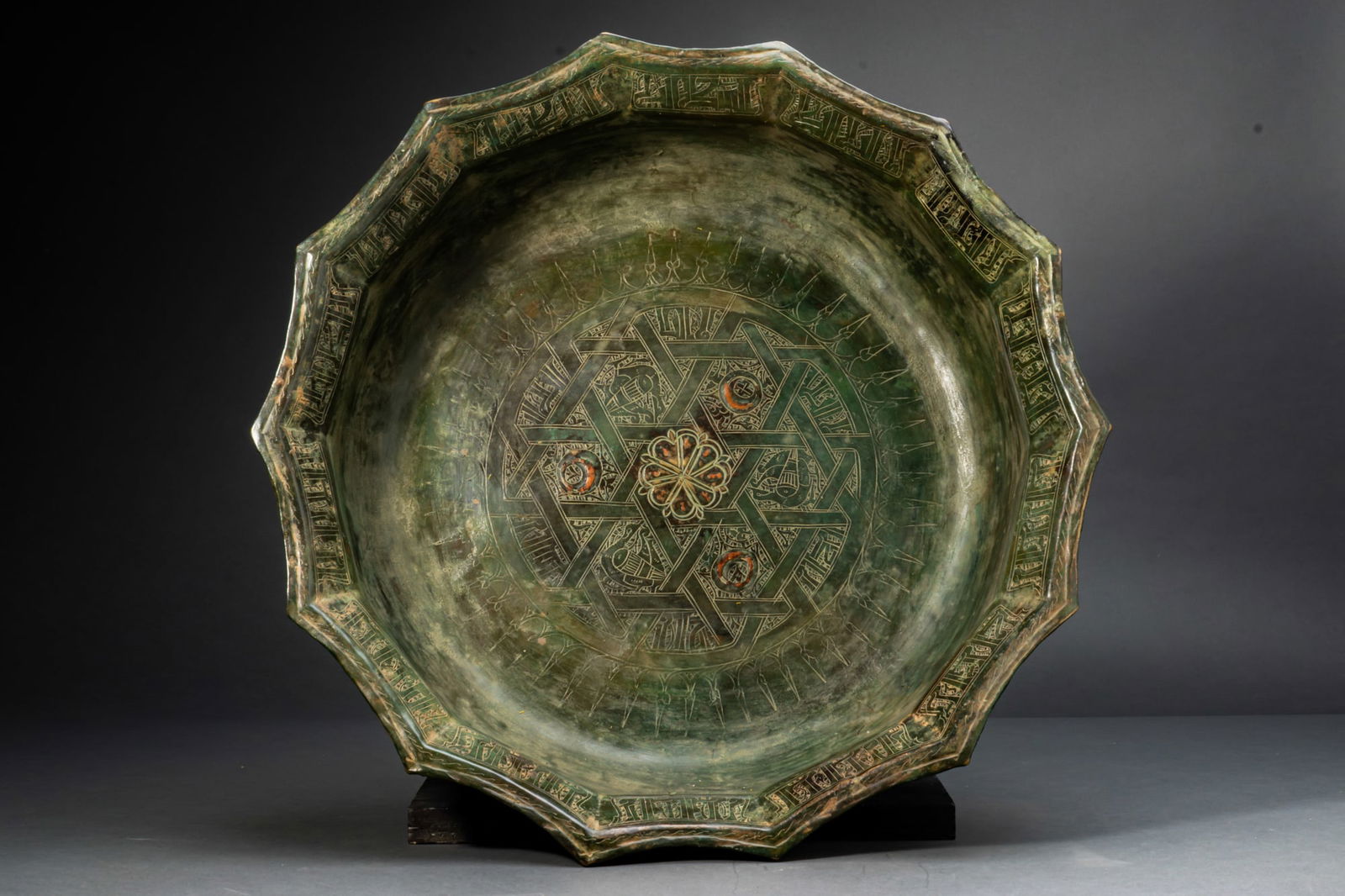 GHAZNAVID BRONZE STAR TRAY WITH FLORAL MOTIFS AND KUFIC INSCRIPTION (1 of 6)