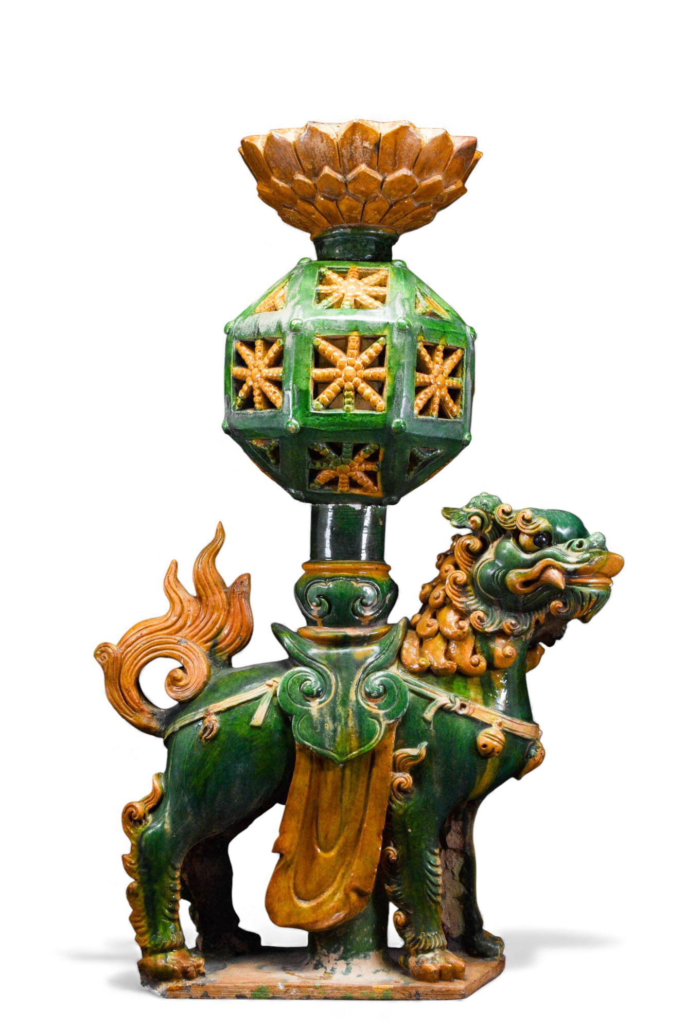 LARGE CHINESE MING DYNASTY AMBER AND GREEN GLAZED ?BUDDHIST LION? STAND: Ca. AD 1368 - 1644 A large ceramic Buddhist Lion stand. The lion is caparisoned, standing on a rectangular plinth, carrying a geometrical vase, was possibly a large temple lamp. Size: 910mm x 600mm; W