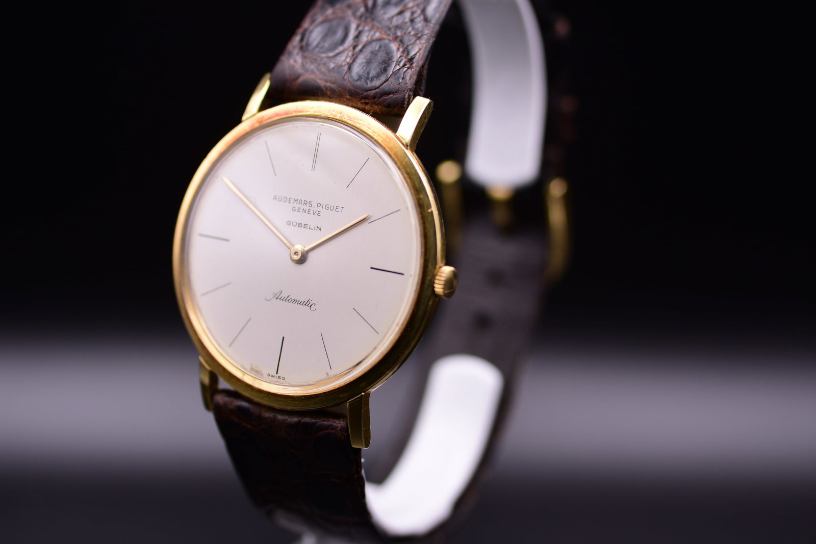 Audemars Piguet 18k Yellow Gold Automatic G?belin Co-Signed Watch c. 1965 Including Box: C. 1965AThis exceptional Audemars Piguet automatic wristwatch, circa 1965, presents a rare blend of prestigious craftsmanship and historical provenance. Encased in lustrous 18k yellow gold, the watch