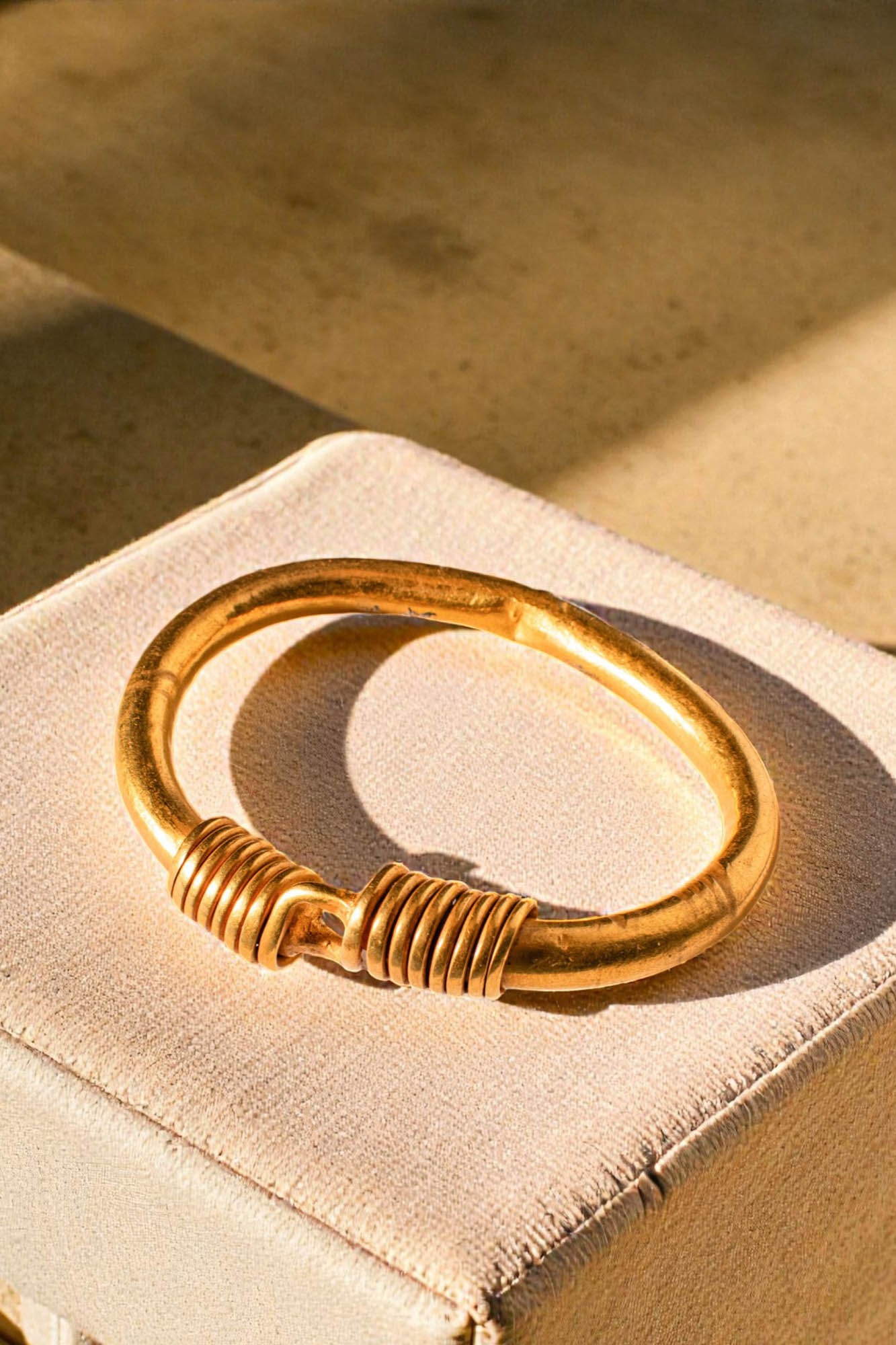 STUNNING EGYPTIAN SOLID HIGH KARAT GOLD BRACELET - PUBLISHED: Late Period, Ca. 664 - 332 BC. A gold bracelet formed as a thick circular hoop with each end narrowing to a round-section wire that wraps around the opposing terminal. For similar see: H. W. Muller, E