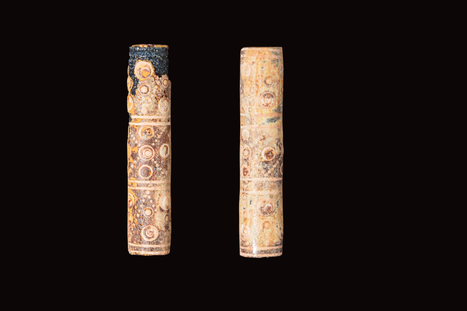 PAIR OF CHINESE WARRING STATES GLASS CYLINDRICAL BEADS: Ca. 475 - 221 BC. A pair of beads, each a long cylinder in blue glass with three registers of white concentric circles and diagonal dotted lines. For similar see: Christie's, Online Auction 20994, Art