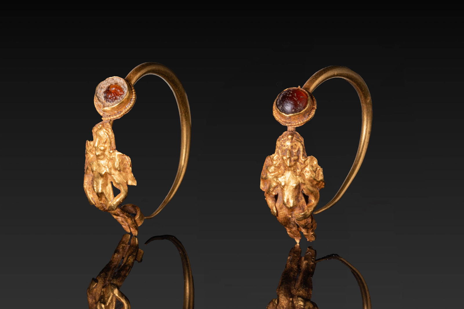 MATCHED PAIR OF HELLENISTIC HIGH KARAT GOLD EROS EARRINGS WITH GARNET CABOCHONS (1 of 8)