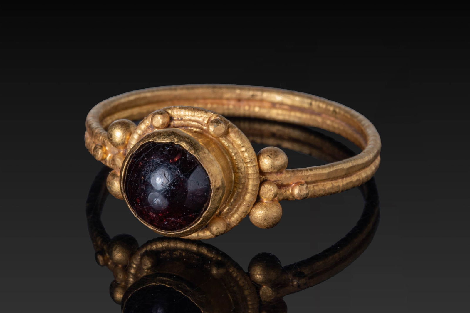LATE ROMAN HIGH KARAT GOLD RING WITH RED GARNET CABOCHON AND HIGH KARAT GOLD PELLETS (1 of 4)