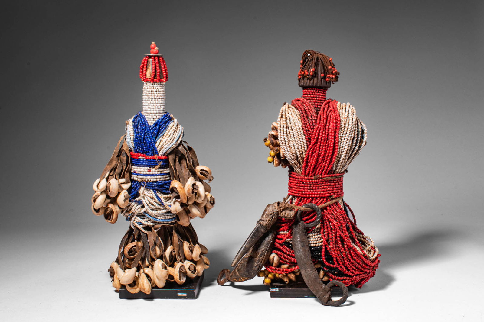 PAIR OF BEAUTIFUL CAMEROON DOWAYO / NAMJI DOLL: Ca. 20th century AD. >A pair of Namji dolls. Each doll is carved as a stylized standing figure with a small wooden core almost entirely concealed beneath elaborate beadwork and ornamentation. The bodi