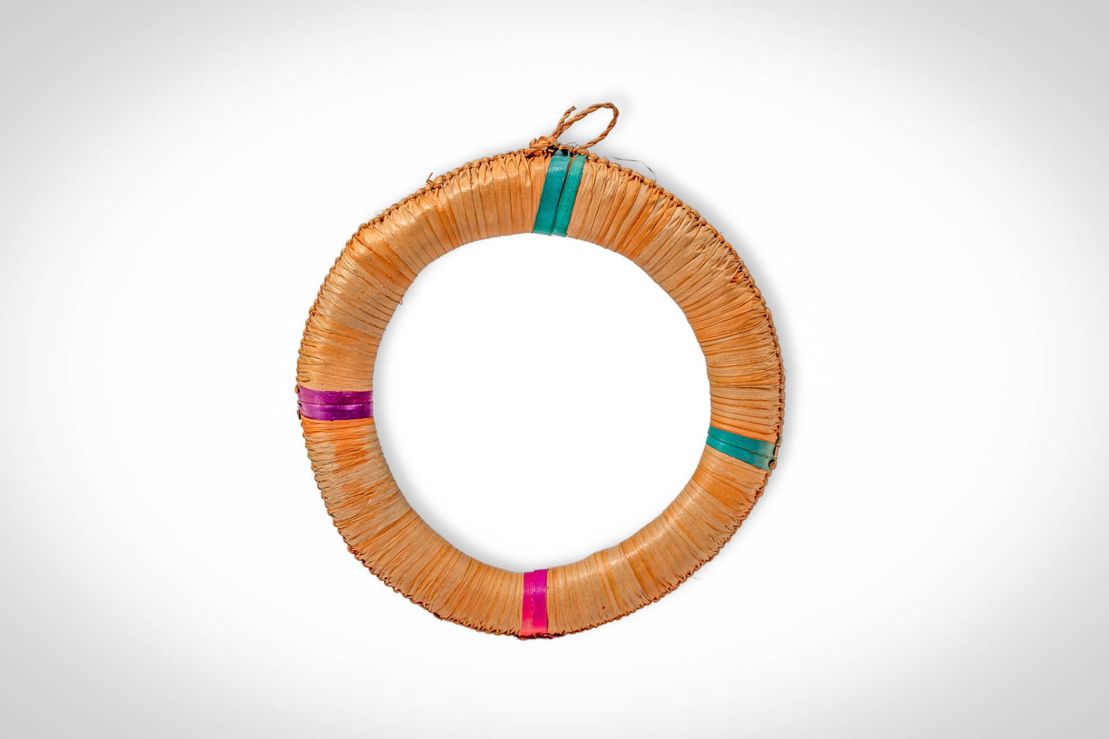 SOUTH AFRICAN NECK ORNAMENT: Ca. 20th century AD. >A circular neck ornament formed from tightly bundled plant fibres bound into a continuous ring. The surface is composed of fine, evenly arranged fibres creating a dense, textured