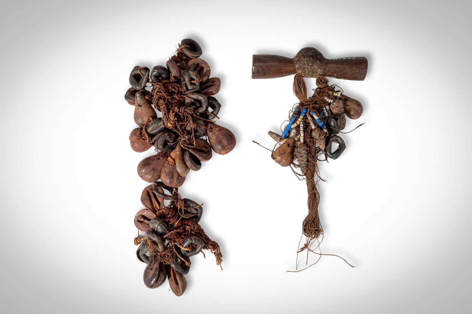 NECKLACE FRAGMENTS: Ca. 20th century AD. >A group of necklace fragments composed of natural shells and plant elements threaded on fibre cords. The larger fragment consists of multiple clusters of dark and reddish-brown s