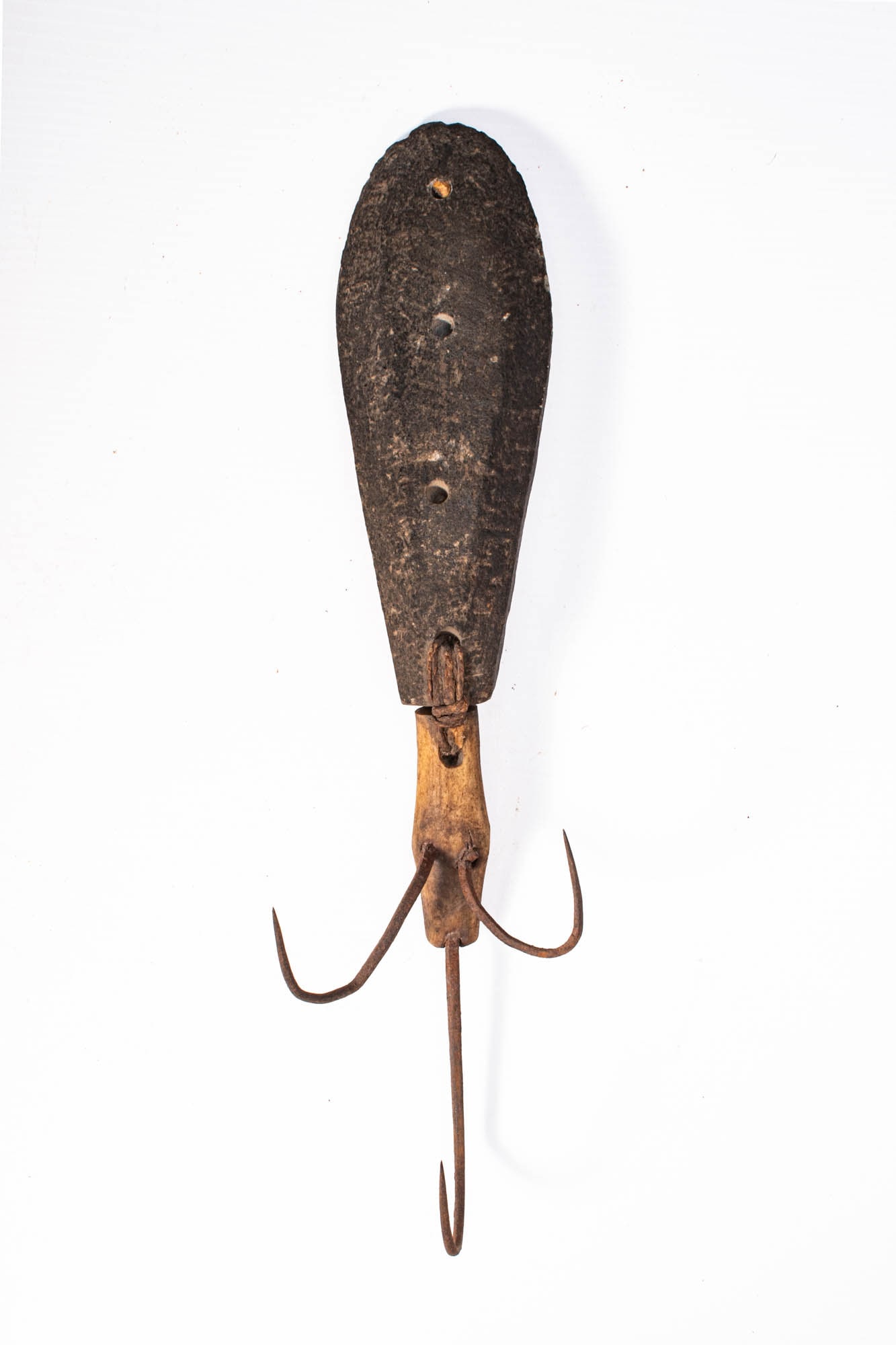 INUIT FISH HOOK: Ca. 19th - early 20th century AD. An Inuit composite fishing implement, consisting of a broad wooden shank with multiple drilled suspension holes, fitted with a central antler extension and three forg