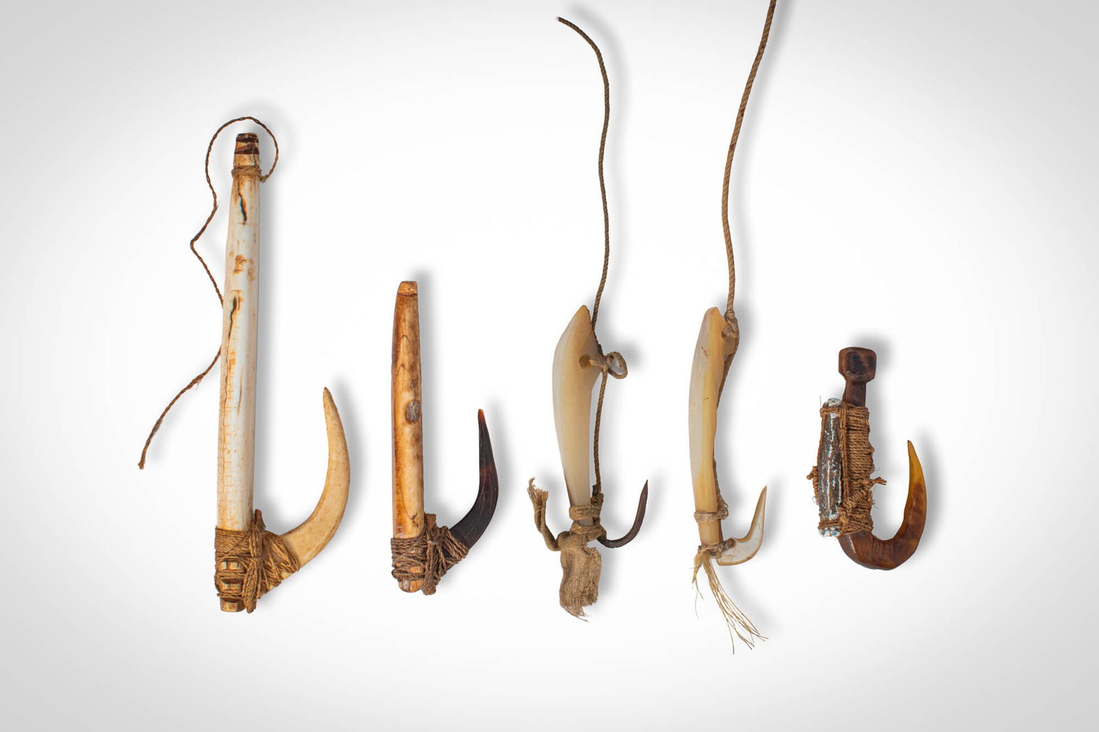 GROUP OF OCEANIC FISH HOOKS: Ca. 19th - 20th century AD. >A group comprising five fish hooks of varying forms, constructed from carved bone or shell elements combined with curved hook points secured by fibre lashings. Several exa