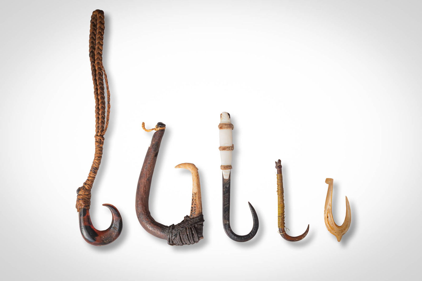 GROUP OF OCEANIC FISH HOOKS: Ca. 19th - 20th century AD. >A group comprising five fish hooks of varying form and construction, each reflecting traditional Oceanic fishing technology. The hooks are carved from wood, bone, or shell