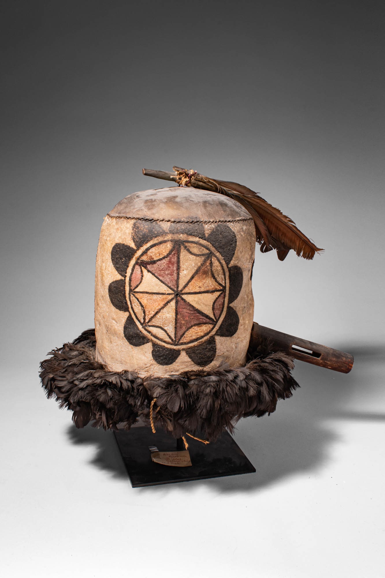 SALIMBOYA ZUNI RITUAL MASK: Ca. 19th - 20th century AD. >An exceptional Salimboya Zuni mask, constructed from shaped hide forming a cylindrical body, the surface is decorated with a bold circular motif composed of geometric segm