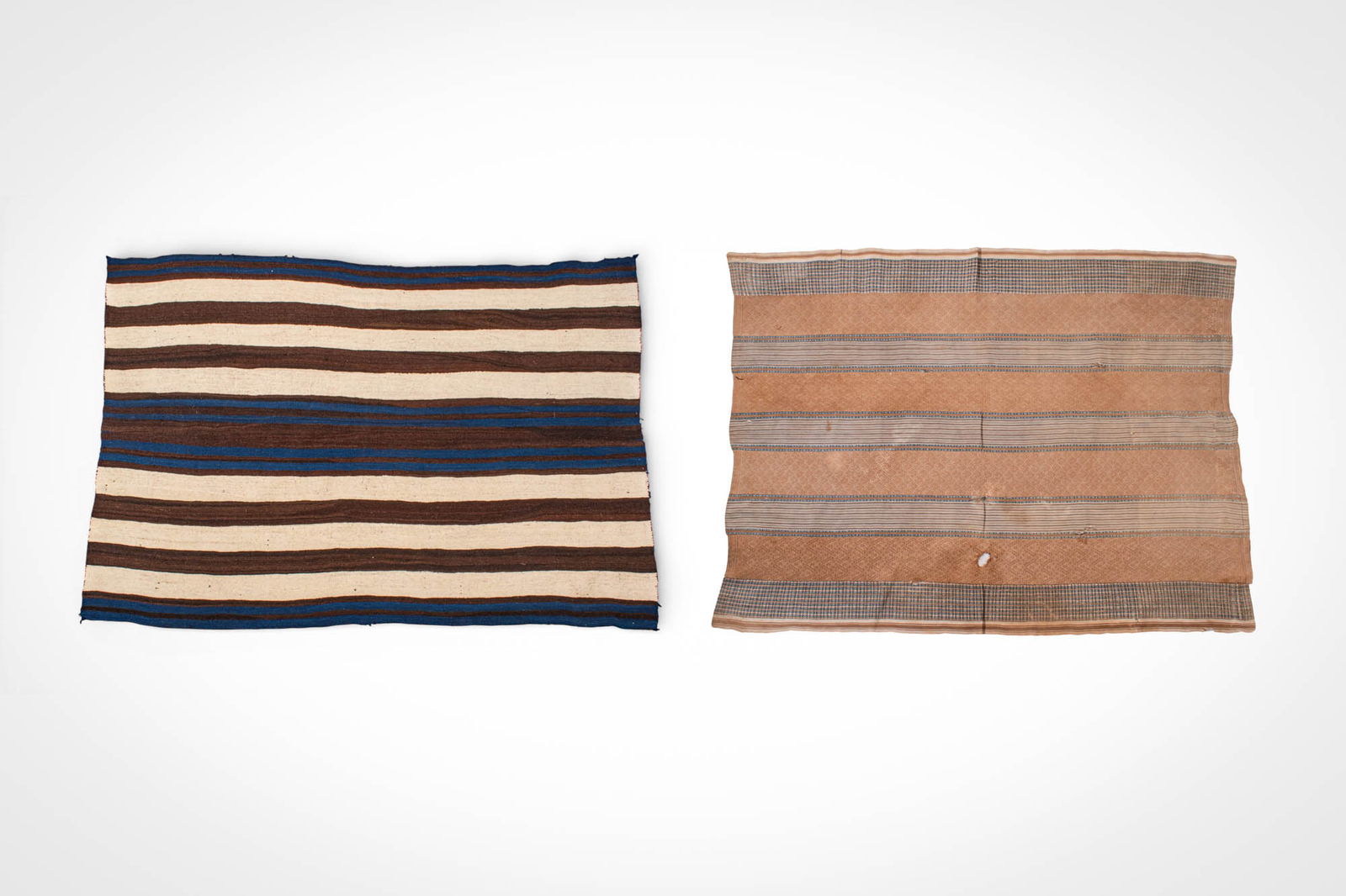 NAVAJO CHIEF'S BLANKETS: Ca. 20th century AD. >A group of two Navajo chief?s blankets, woven in wool and decorated with horizontal banded designs. The first example features alternating broad brown and cream stripes with deep
