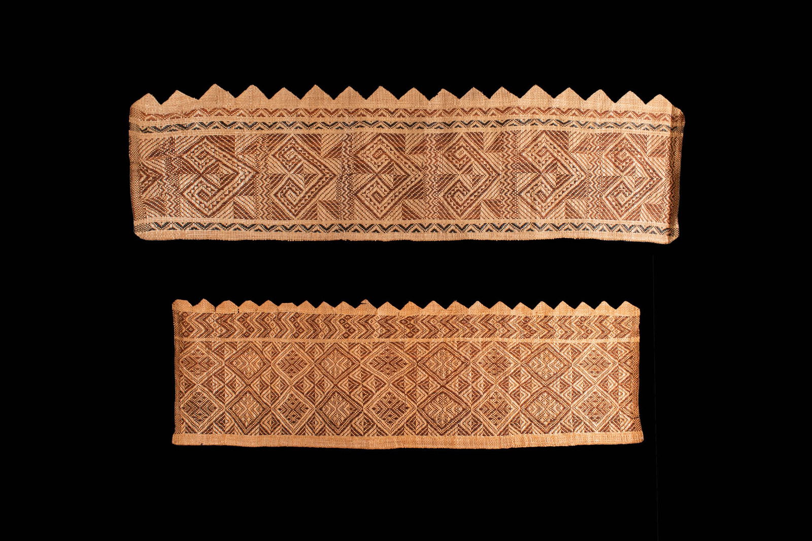 OCEANIC WOVEN TEXTILE BORDER: Ca. 19th century AD. A finely executed textile border with intricate geometric designs, likely woven from plant fibres and dyed with natural pigments. The stepped triangular edging adds a decorative f
