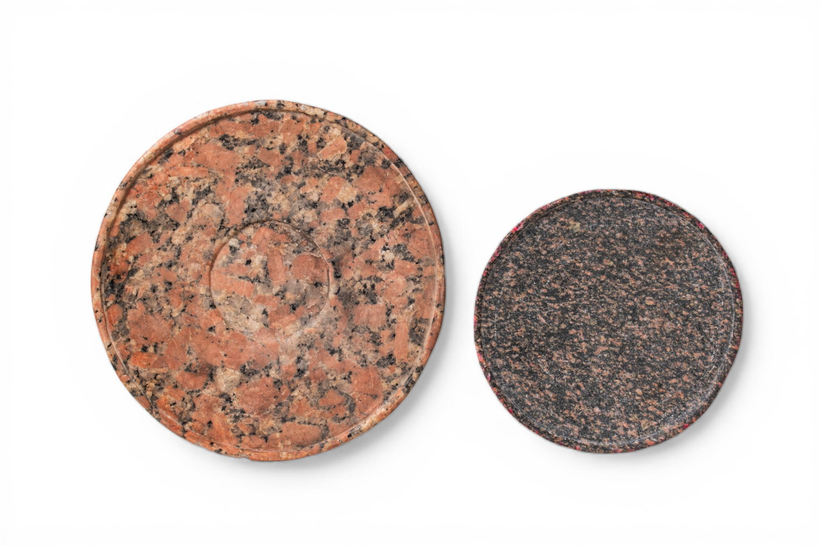 PAIR OF EGYPTIAN GRANITE OFFERING PLATES: Old Kingdom, Ca. 2600 - 2200 BC. A pair of granite offering plates, each carved as a shallow circular dish with a low upturned rim, the larger with a roundel at the centre. For similar see: The Metrop
