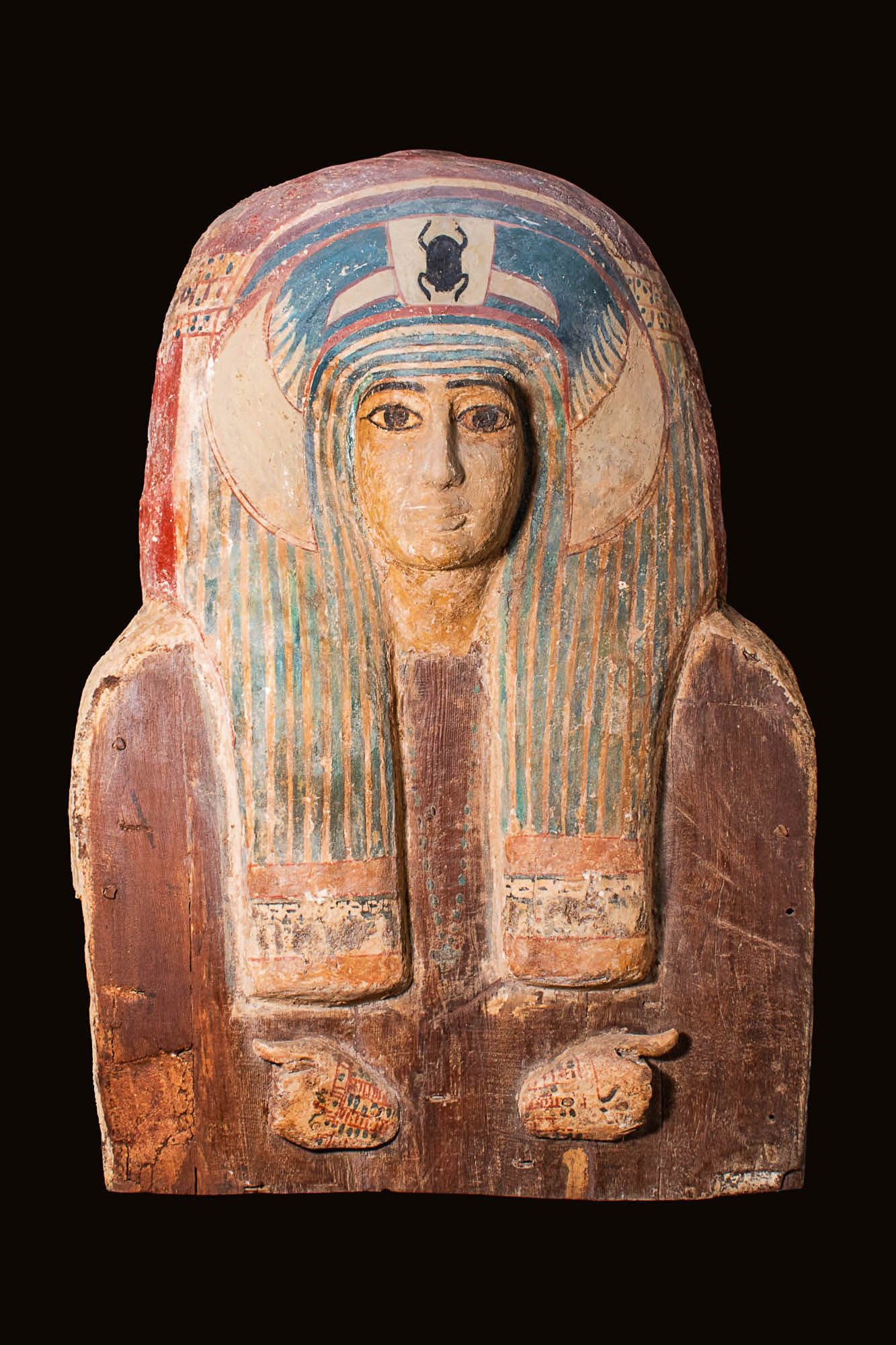 UPPER PART OF A LID OF EGYPTIAN WOODEN COFFIN: Third Intermediate Period, 22nd-25th Dynasties, Ca. 945 - 700 BC; probably from Lower Egypt.. An upper part of lid of a wooden coffin decorated with polychrome painted gesso. It features a vulture hea