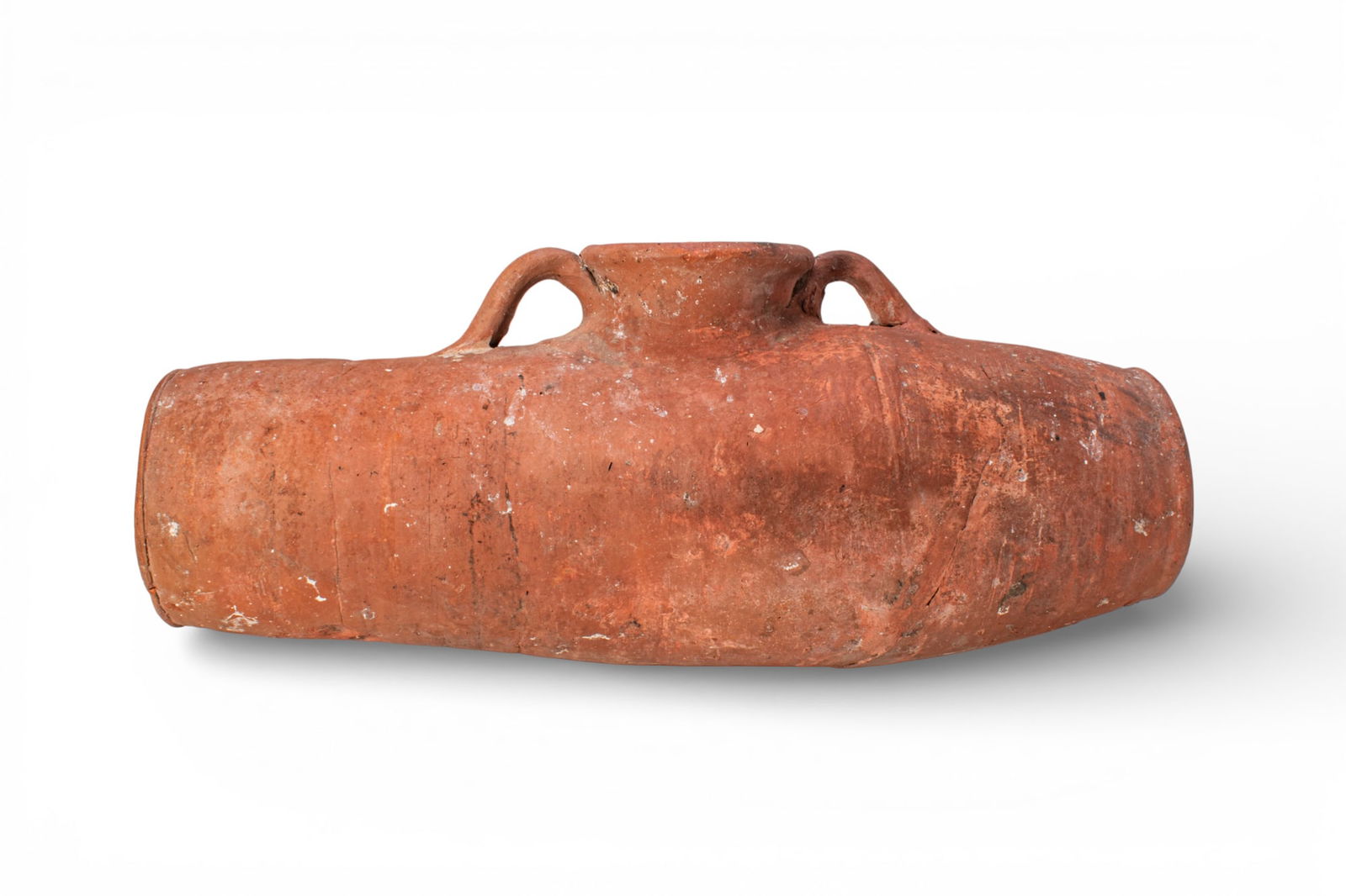 LARGE EGYPTIAN TERRACOTTA ASKOS: Amarna Period, Ca. 1353 - 1335 BC. A large terracotta askos with an elongated tubular body, slightly tapering towards one end and finished with flat circular terminals. A wide cylindrical spout rises