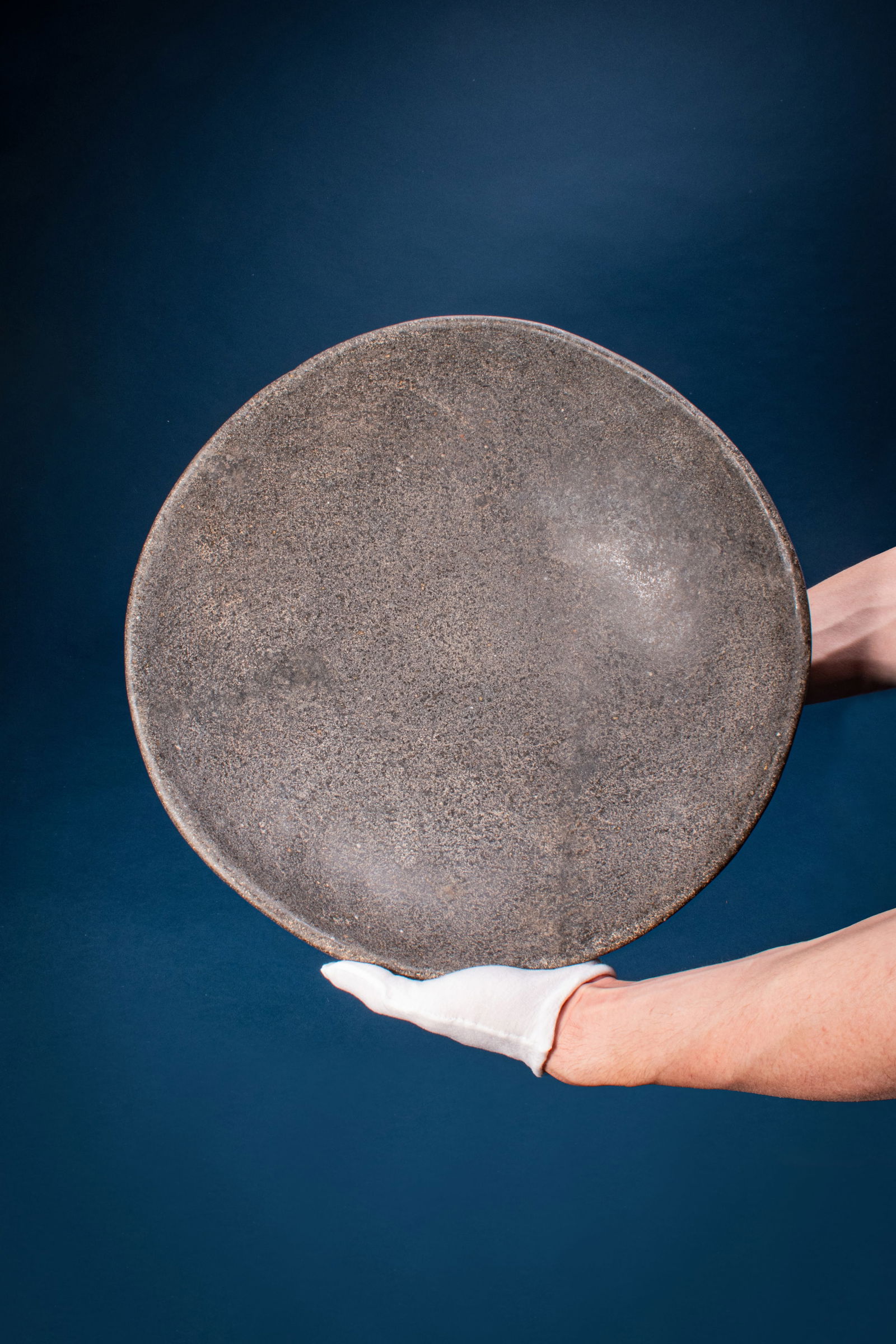 HUGE EGYPTIAN STONE OFFERING BOWL: Early Dynastic, Ca. 2900 - 2640 BC. A speckled stone offering bowl with a wide hemispherical body raised on a low ring foot. For similar see: The Metropolitan Museum of Art, Object Number: 38.7. Size: