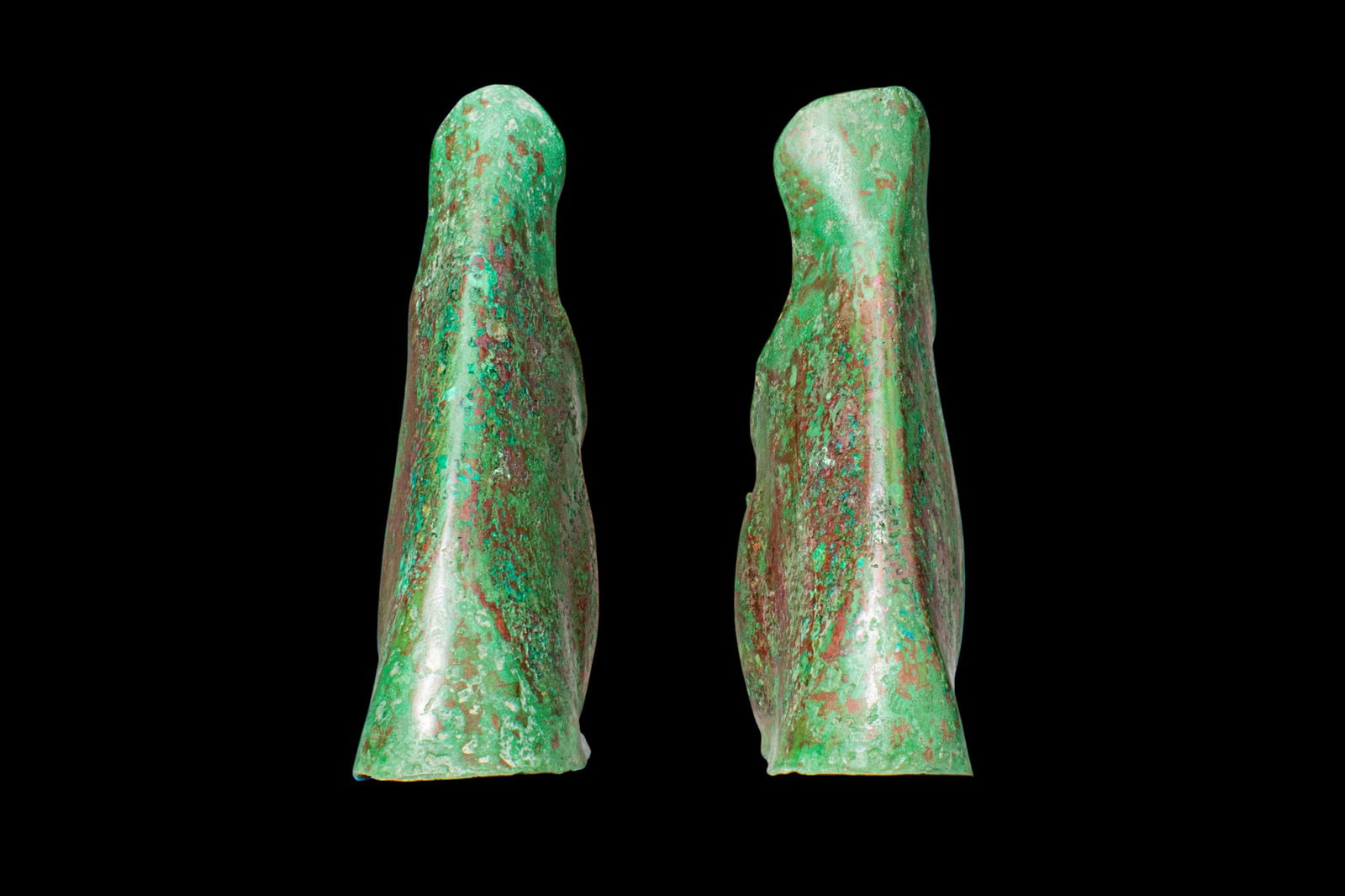 STUNNING PAIR OF GREEK BRONZE ANKLE GUARDS: Ca. 500 - 400 BC. A pair of bronze ankle guards formed from thin hammered sheet, each with a high flaring upper edge and a curved lower section wrapping around the ankle, left open at the rear with ov