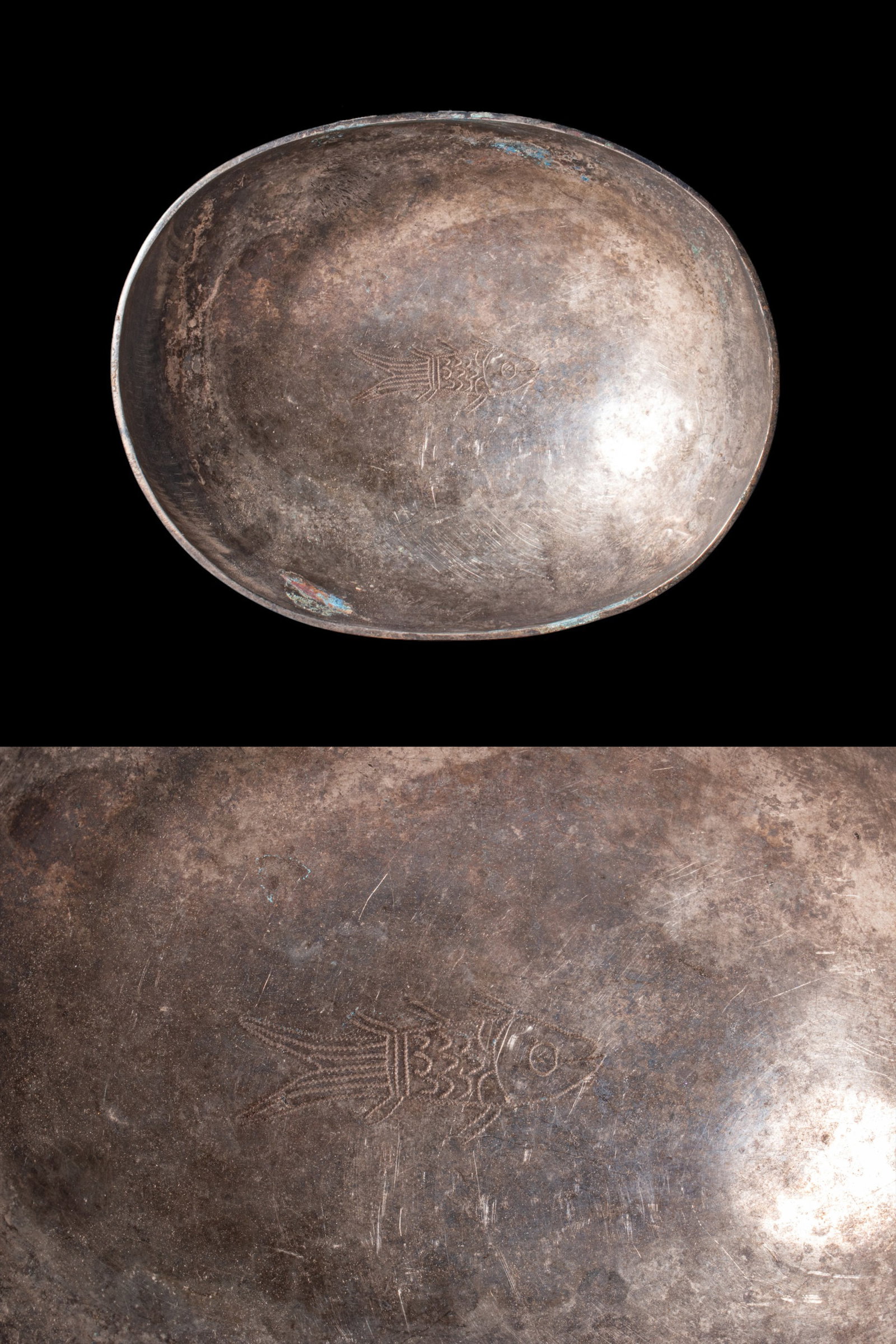 SASANIAN SILVER ELLIPTICAL BOWL WITH FISH: Ca. AD 500 - 600. A silver bowl of shallow, elliptical plan, with a curving wall and a thin, plain lip. The interior base is engraved with a fish shown in profile, with hatched fins and a scaled body,