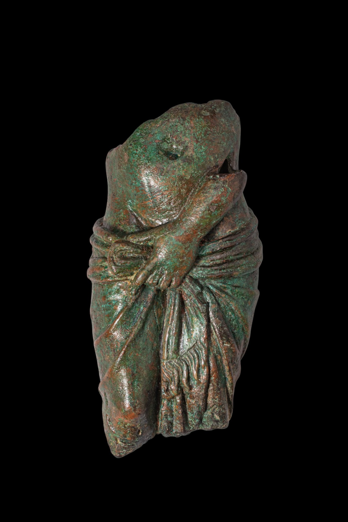 ROMAN BRONZE VENUS AT THE BATH FIGURINE: Ca. AD 200. A bronze figurine of bathing Venus, standing in contrapposto with a mantle gathered at the hips. The body is rendered with soft anatomical modelling, with the left arm drawing the garment