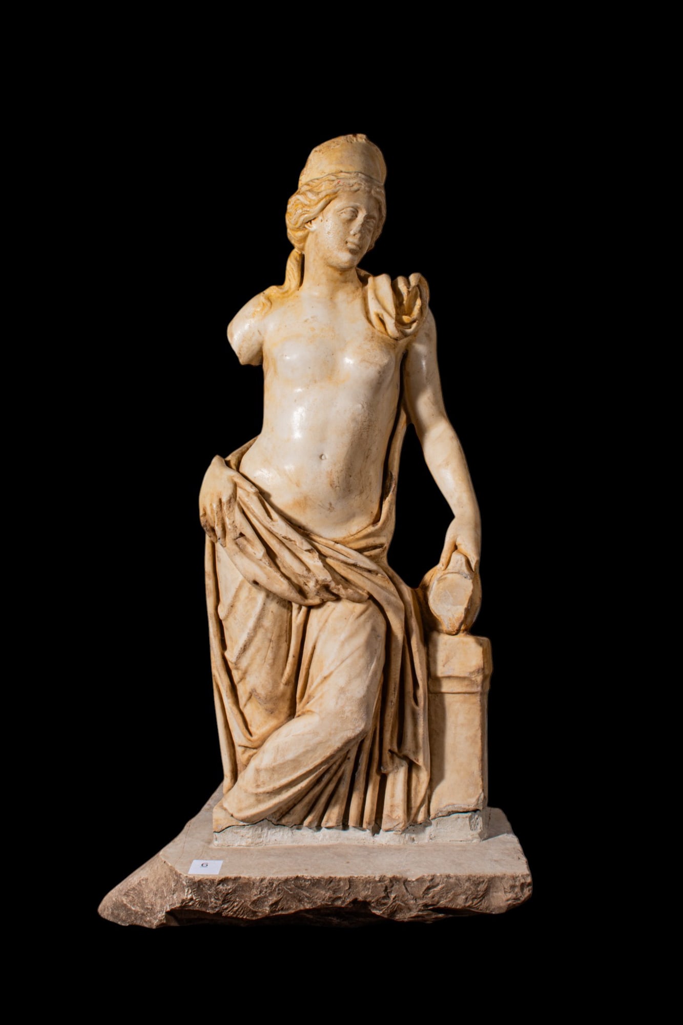 ROMAN MARBLE STATUE OF APHRODITE-LIKE NAIAD (NYMPH) OF A FOUNTAIN OR SPRING: Ca. AD 100 - 200. This half life-size (73 cm) marble statue depicts a semi-nude female figure, sculpted with refined modeling and a meticulously polished surface. The torso, face, and arms are finishe