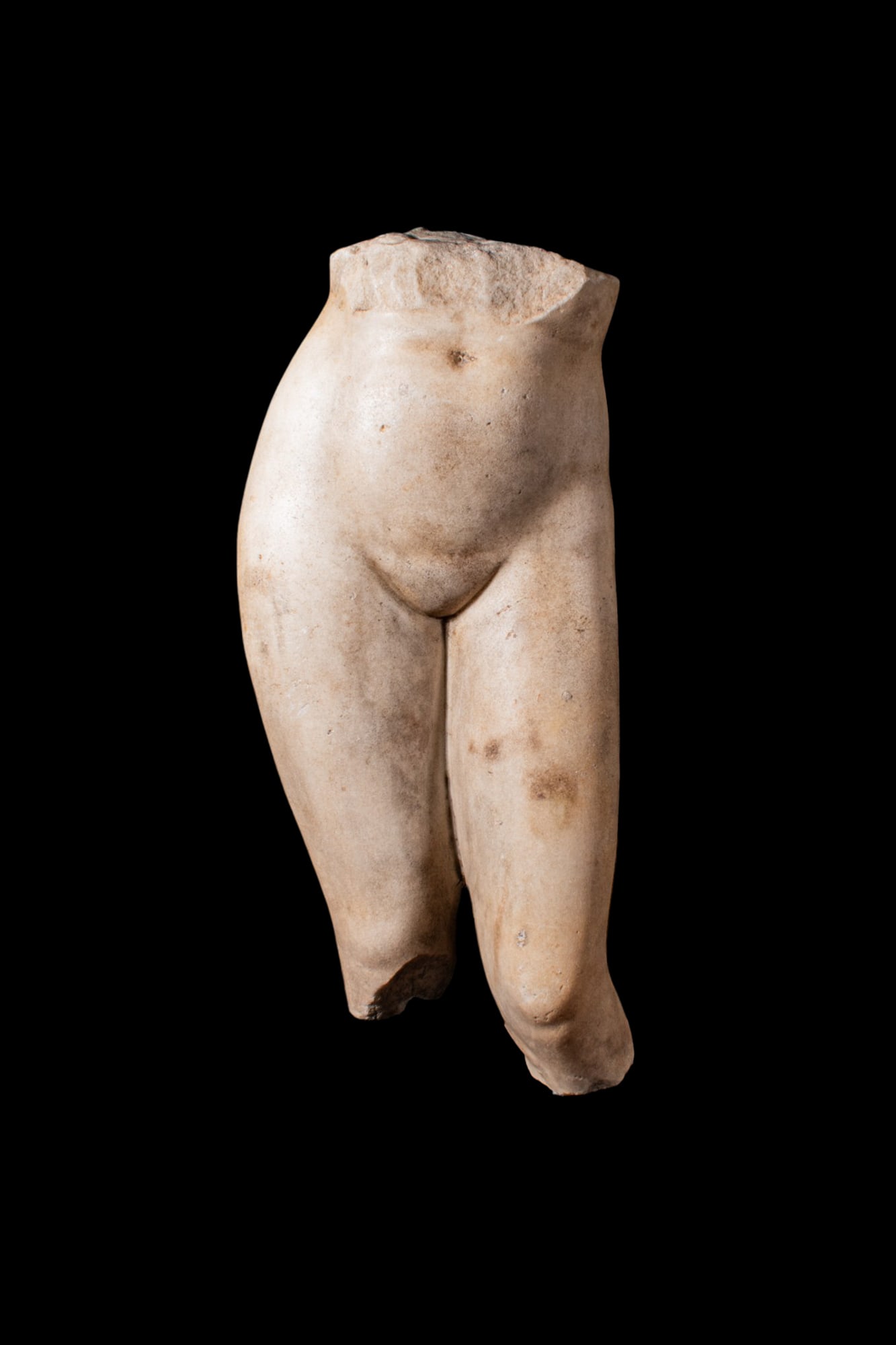 ROMAN MARBLE LIFE SIZE LOWER TORSO OF APHRODITE OF CYRENE TYPE: Ca. AD 1 - 300. A marble life size fragment of an Aphrodite Cyrene Type, comprising the lower torso from the waist and the legs to just below the knees. The abdomen is smoothly modelled with a shallow