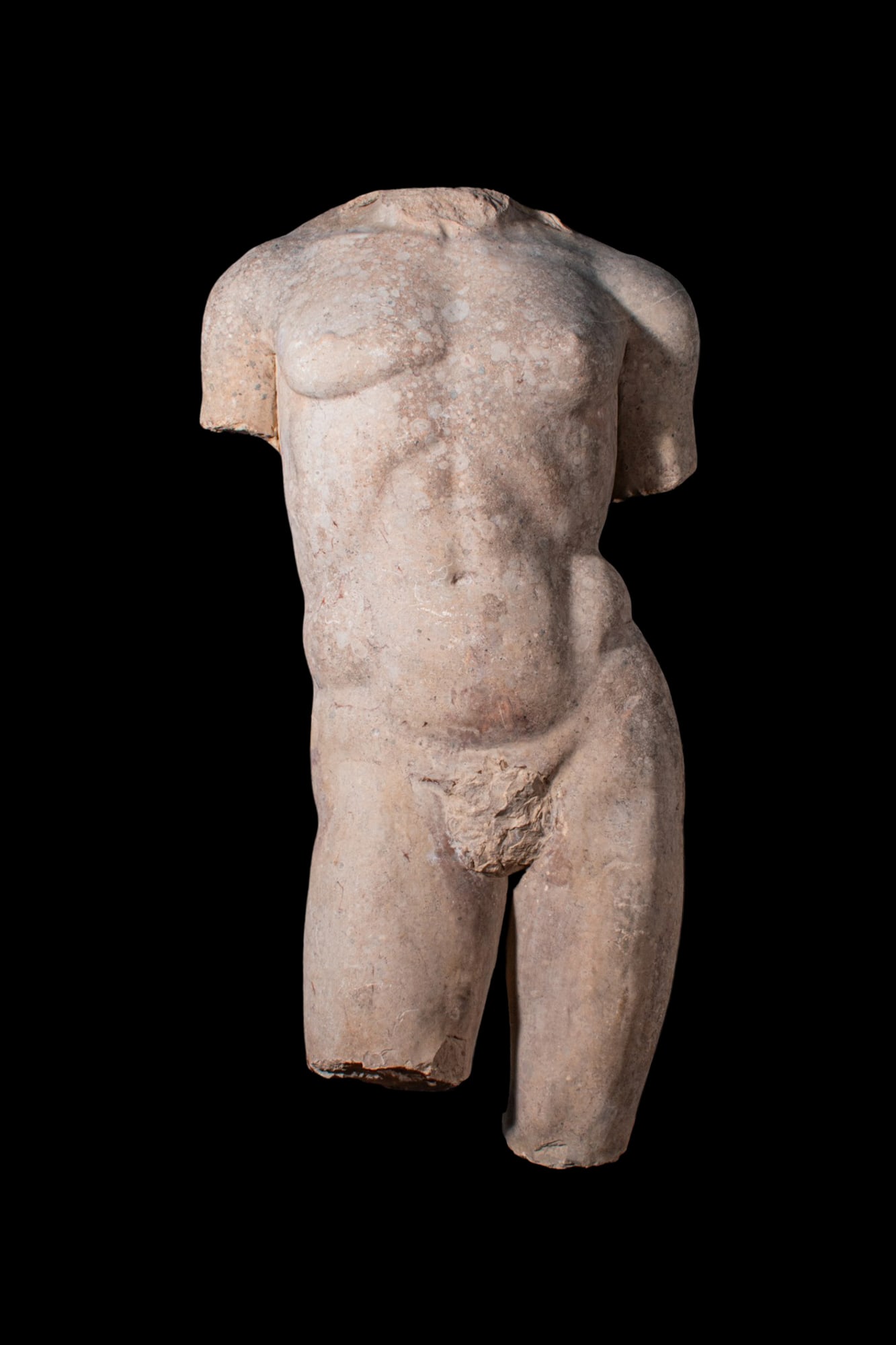 OVER LIFE SIZE GRAECO-ROMAN TORSO OF YOUTHFUL GOD APOLLO: Ca. AD 1 - 200. A breccia torso of youthful god Apollo, shown in contrapposto, the weight set on the left leg with the right leg advanced. The chest is broad above a narrow waist, and the abdomen soft