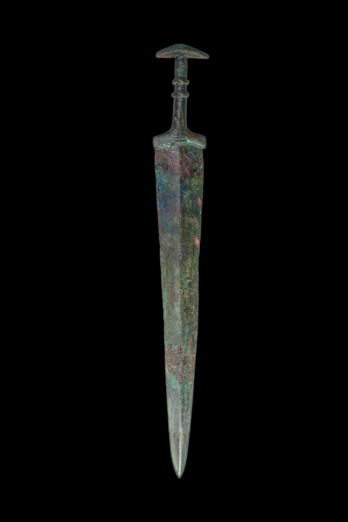 STUNNING BRONZE AGE / EARLY GREEK PERIOD BRONZE DAGGER: Ca. 1200 - 800 BC. A bronze dagger cast with a long, tapering blade of narrow triangular profile, with a pronounced central midrib running from the shoulders to the point, the integral guard leading t