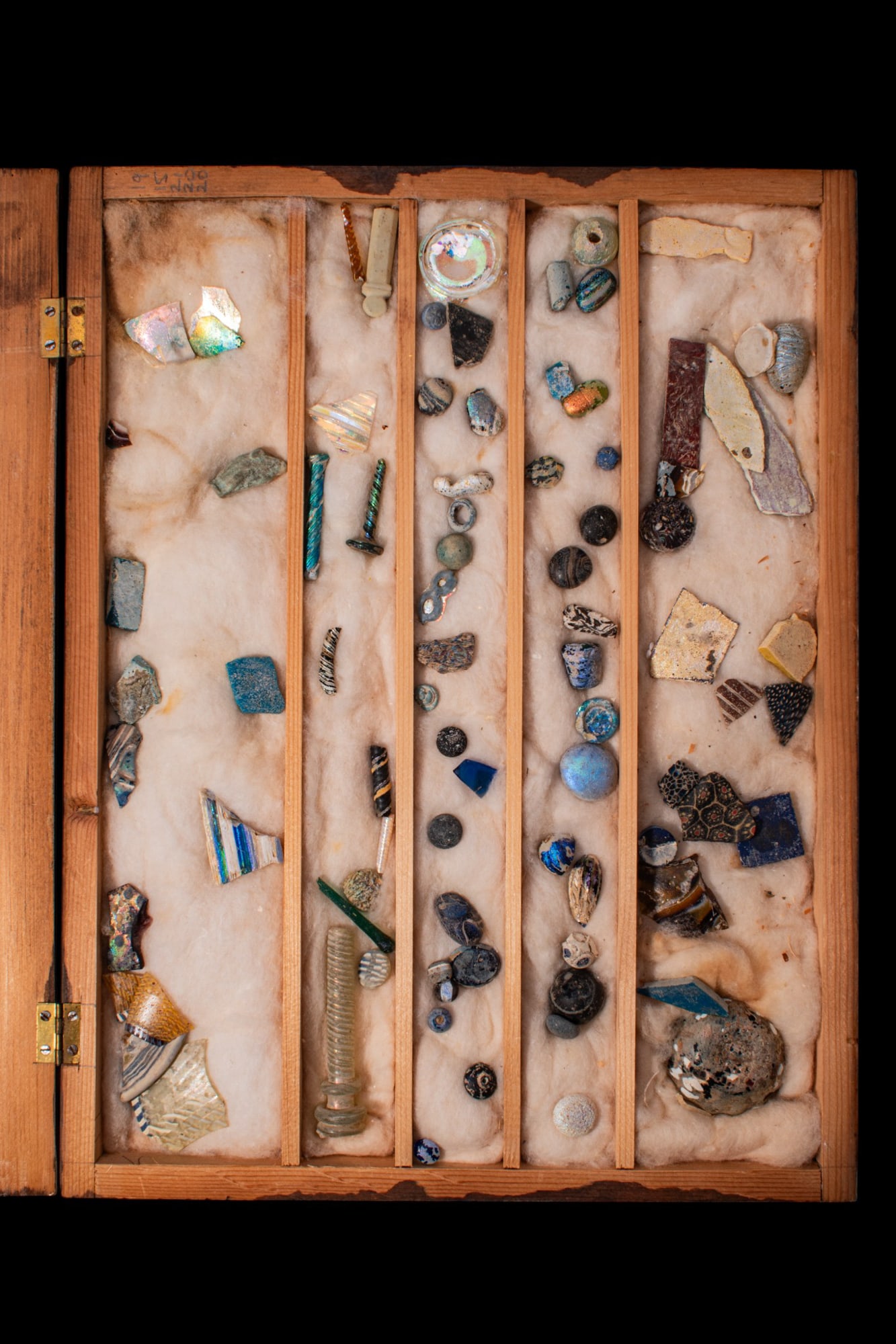 COLLECTION OF ROMAN POLYCHROME GLASS SECTILIA: Ca. 100 BC - AD 100. A collection of polychrome glass pieces, including assorted inlay fragments; mosaic, marbled and banded glass in varied colours; and a group of small objects including beads, ear