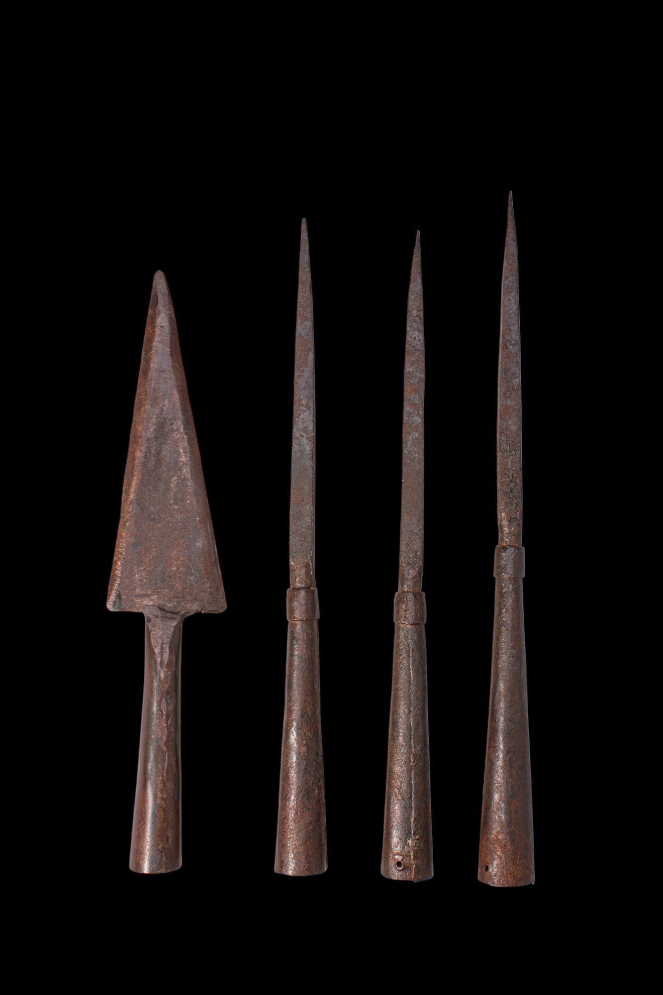 COLLECTION OF MEDIEVAL IRON SPEARHEADS: Ca. AD 1400 - 1700. A collection of 10 iron spearheads, including a broad triangular head with a cylindrical socket; four spike-like heads with long tapering points and collared sleeves; and five spea
