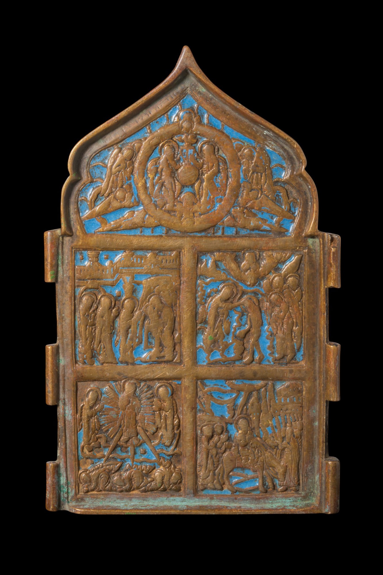 ORTHODOX ENAMELLED BRONZE ICON: Ca. AD 1750 - 1850. A bronze panel from a four-part folding quadriptych travelling icon, with a pointed arch, framed by a raised border and divided into compartments with relief scenes from the Life o