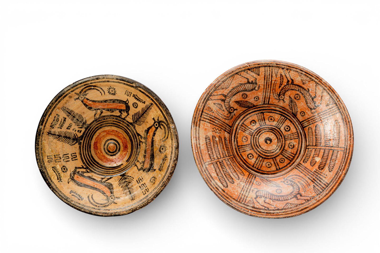 PAIR OF INDUS VALLEY DISHES WITH QUADRUPEDS: Ca. 2500 - 1800 BC. A pair of shallow terracotta dishes, from left to right: a dish in buff fabric, with a central concentric medallion and an encircling frieze of stylised quadrupeds alternating with