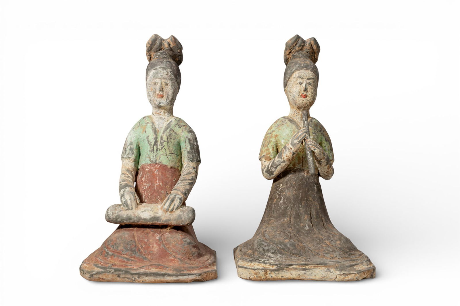 PAIR OF CHINESE TERRACOTTA SEATED FEMALE MUSICIANS - TL TESTED: Tang dynasty, Ca. AD 618 - 907. A pair of terracotta female figures, each shown seated upright on an integral rectangular base, the long robes spread over the legs, with a short upper garment and long